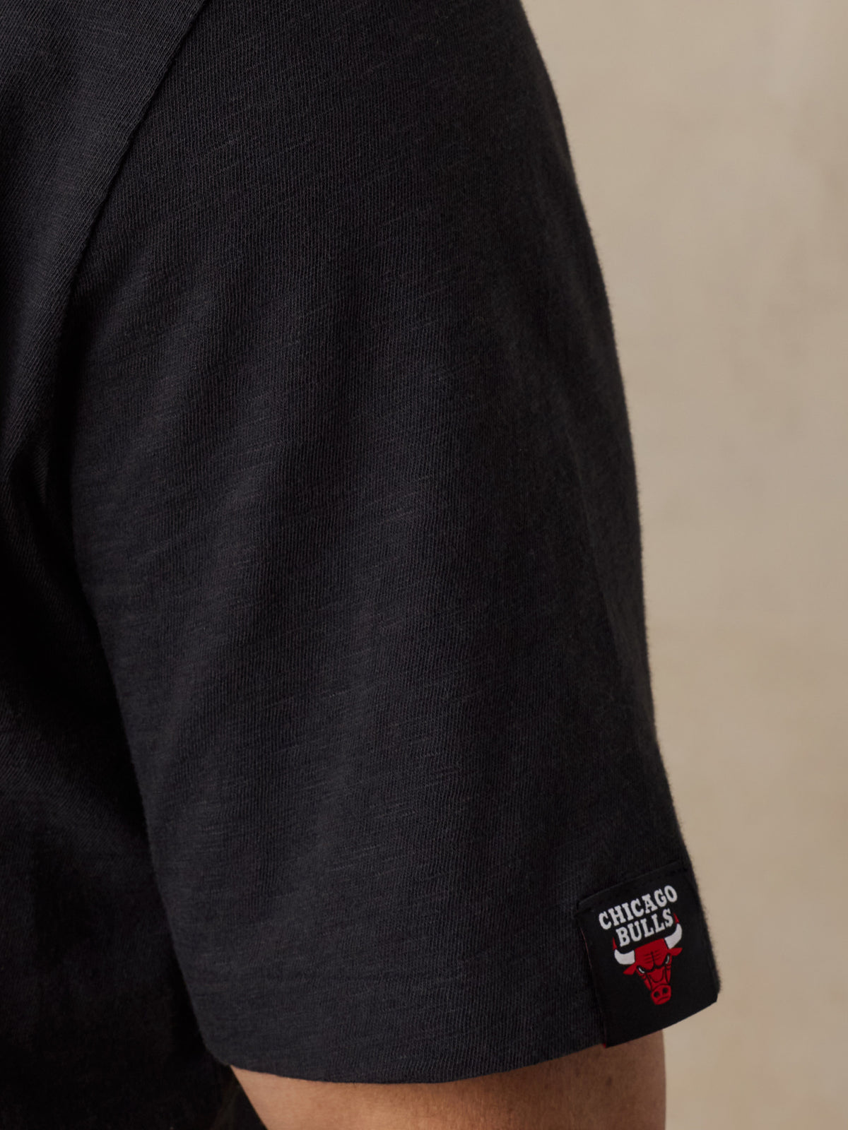 Close up of a man wearing a black Chicago Bulls tee, image 3 of 6