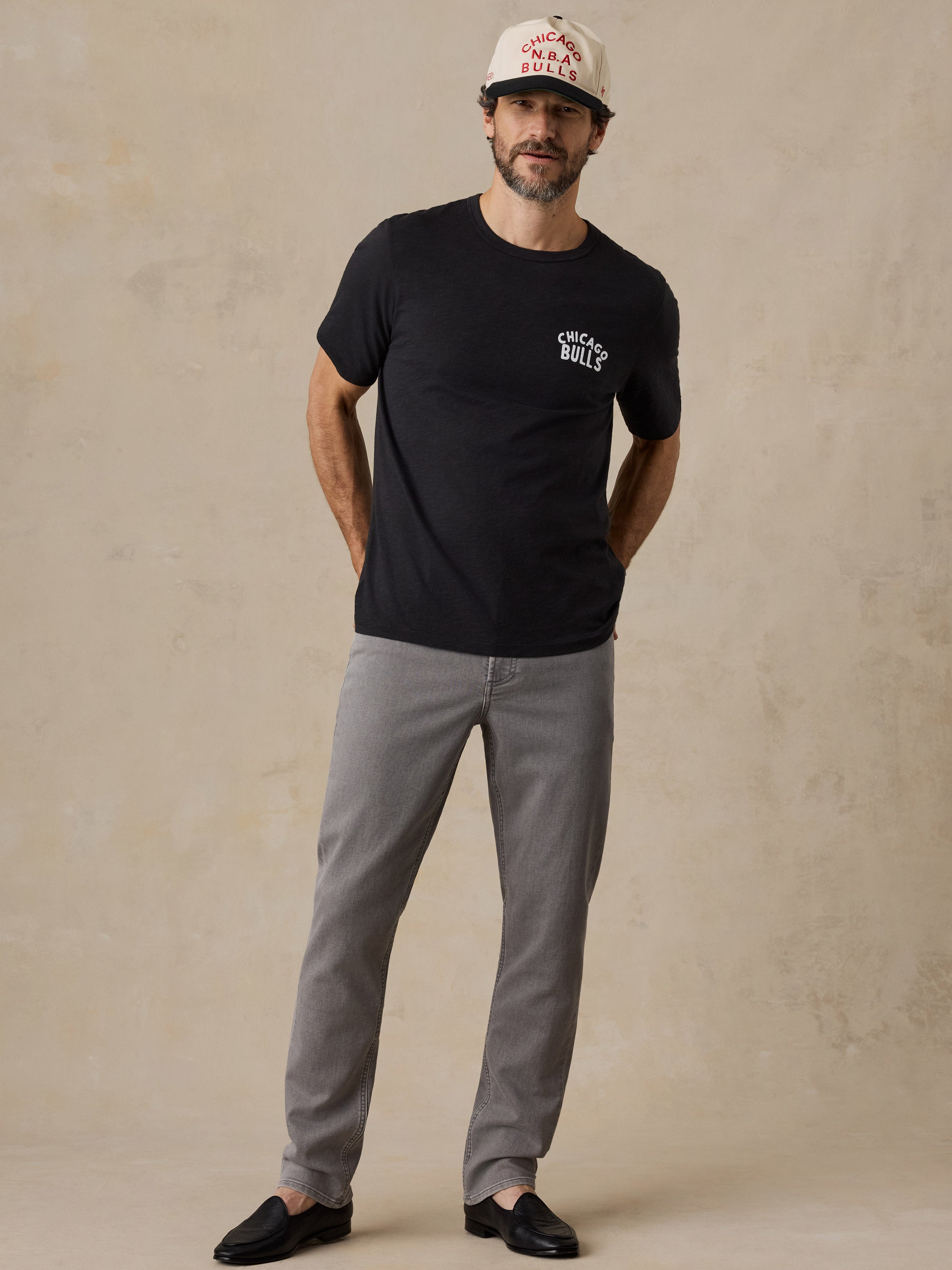 A man wearing a black Chicago bulls tee and hat