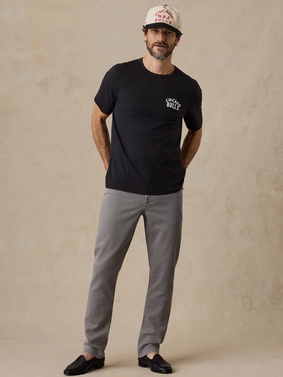 A man wearing a black Chicago bulls tee and hat, image 6 of 6