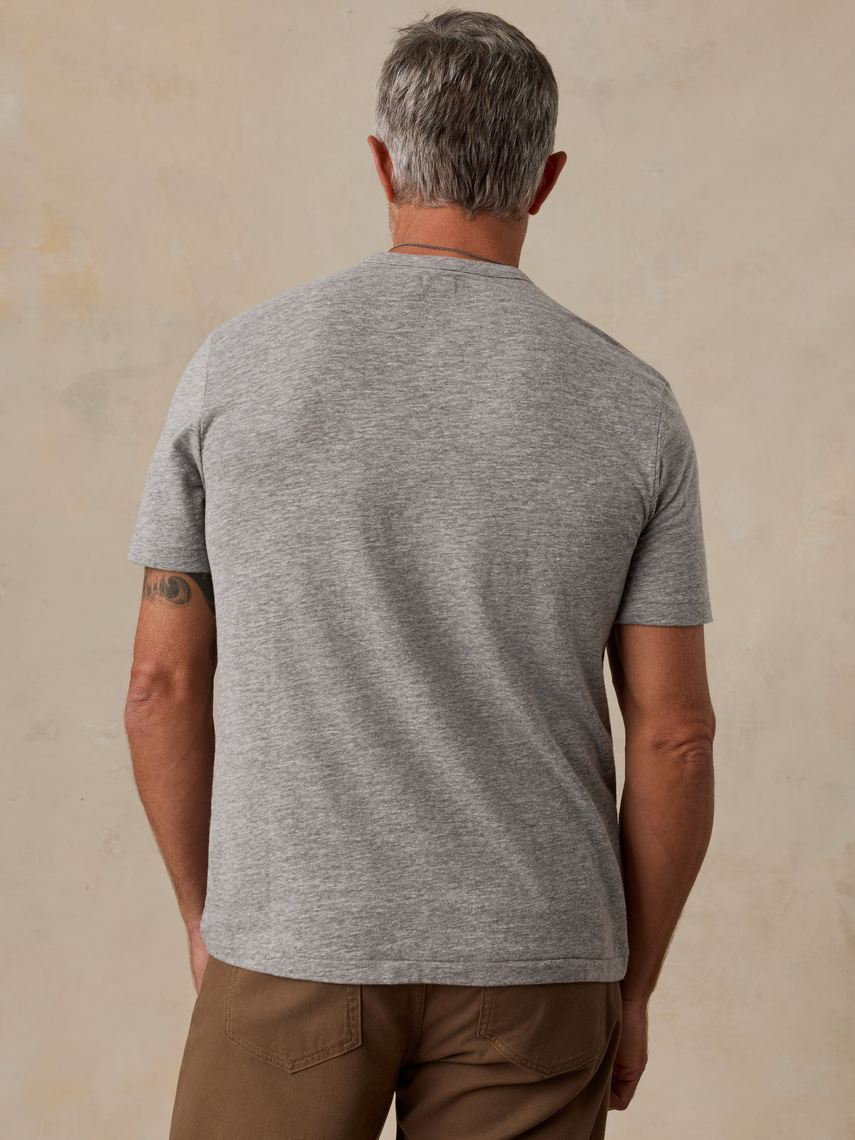 A man viewed from behind wearing a grey Chicago Bulls tee, image 4 of 6