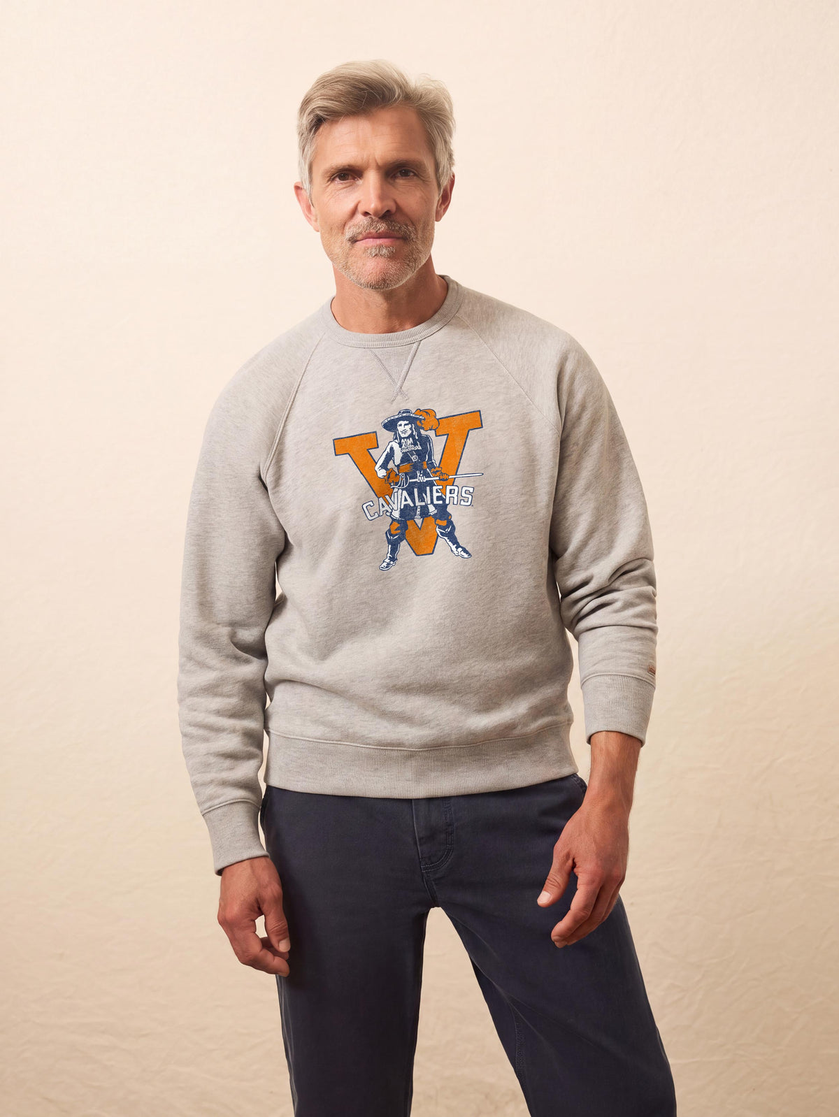 A man wearing a University of Virginia crewneck and blue pants, image 1 of 1
