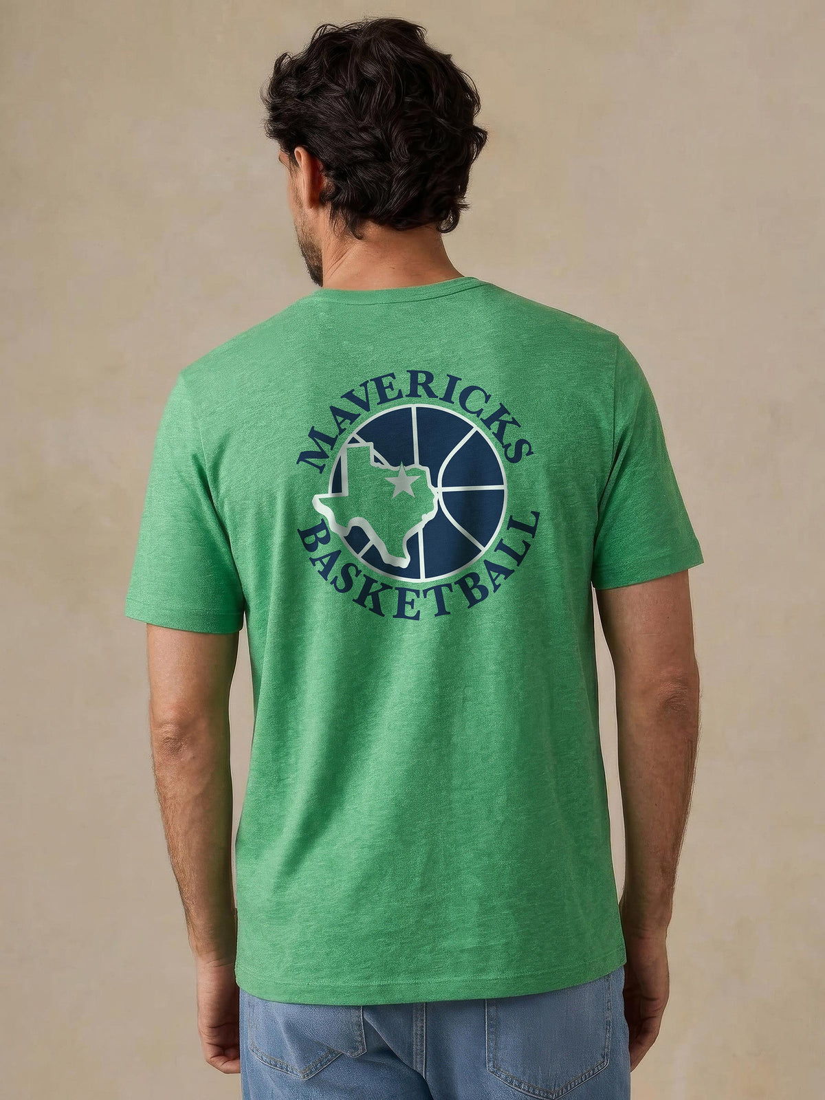 A man viewed from behind wearing a green Dallas Mavericks tee, image 2 of 4