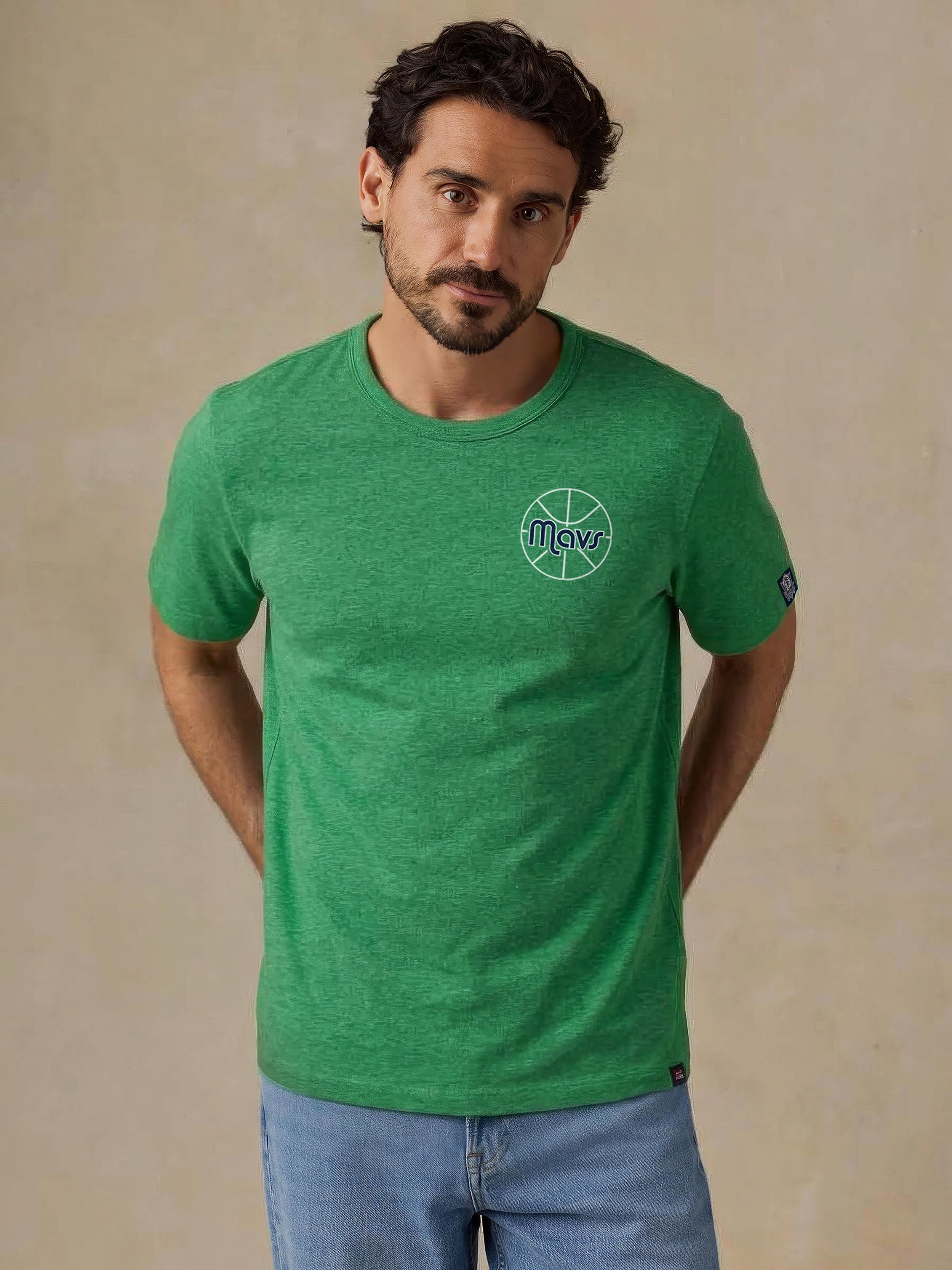 A man wearing a green Dallas Mavericks tee