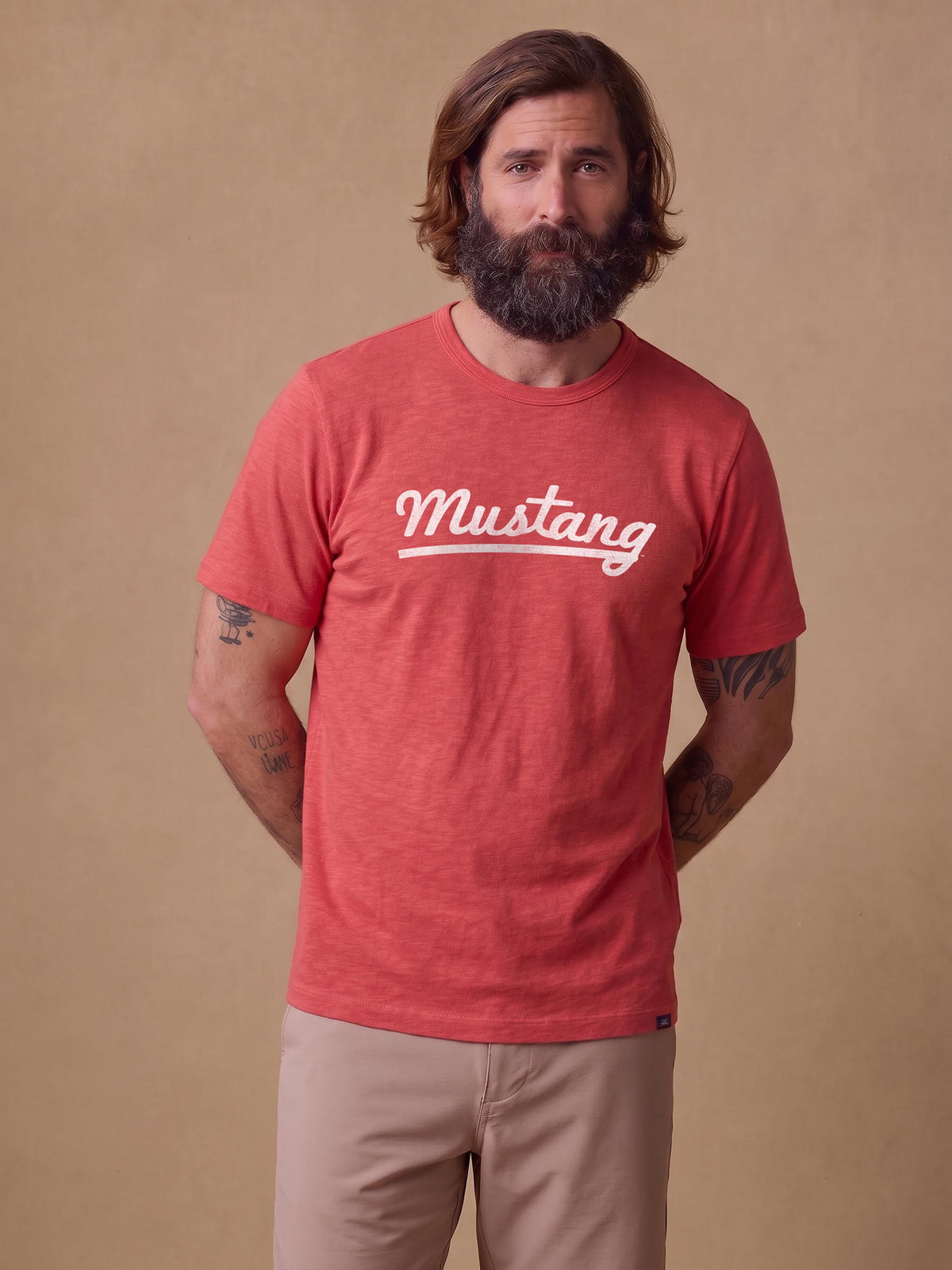 A man wearing a red SMU tee and beige pants, image 1 of 1