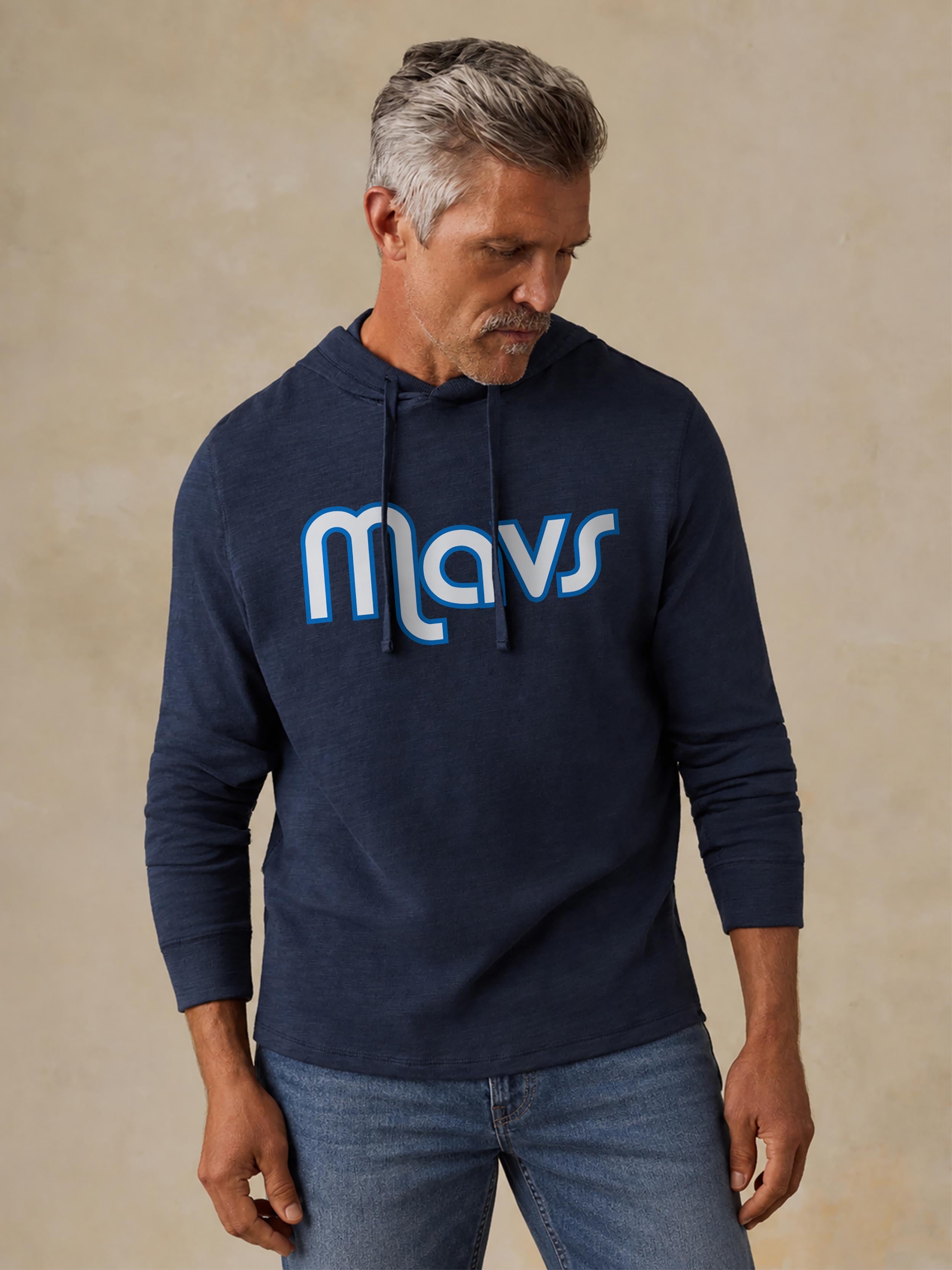 A man wearing a blue Dallas Mavericks hoodie