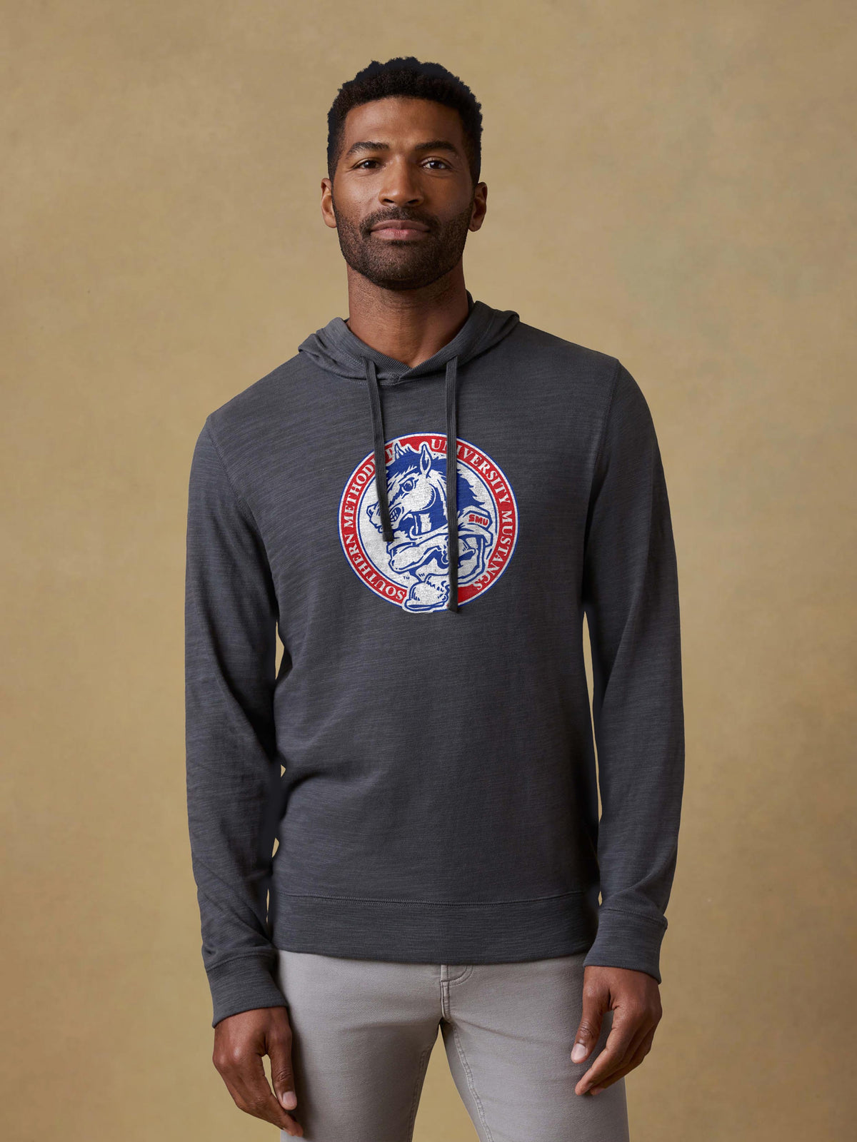 A man wearing a grey SMU hoodie and grey pants, image 1 of 1