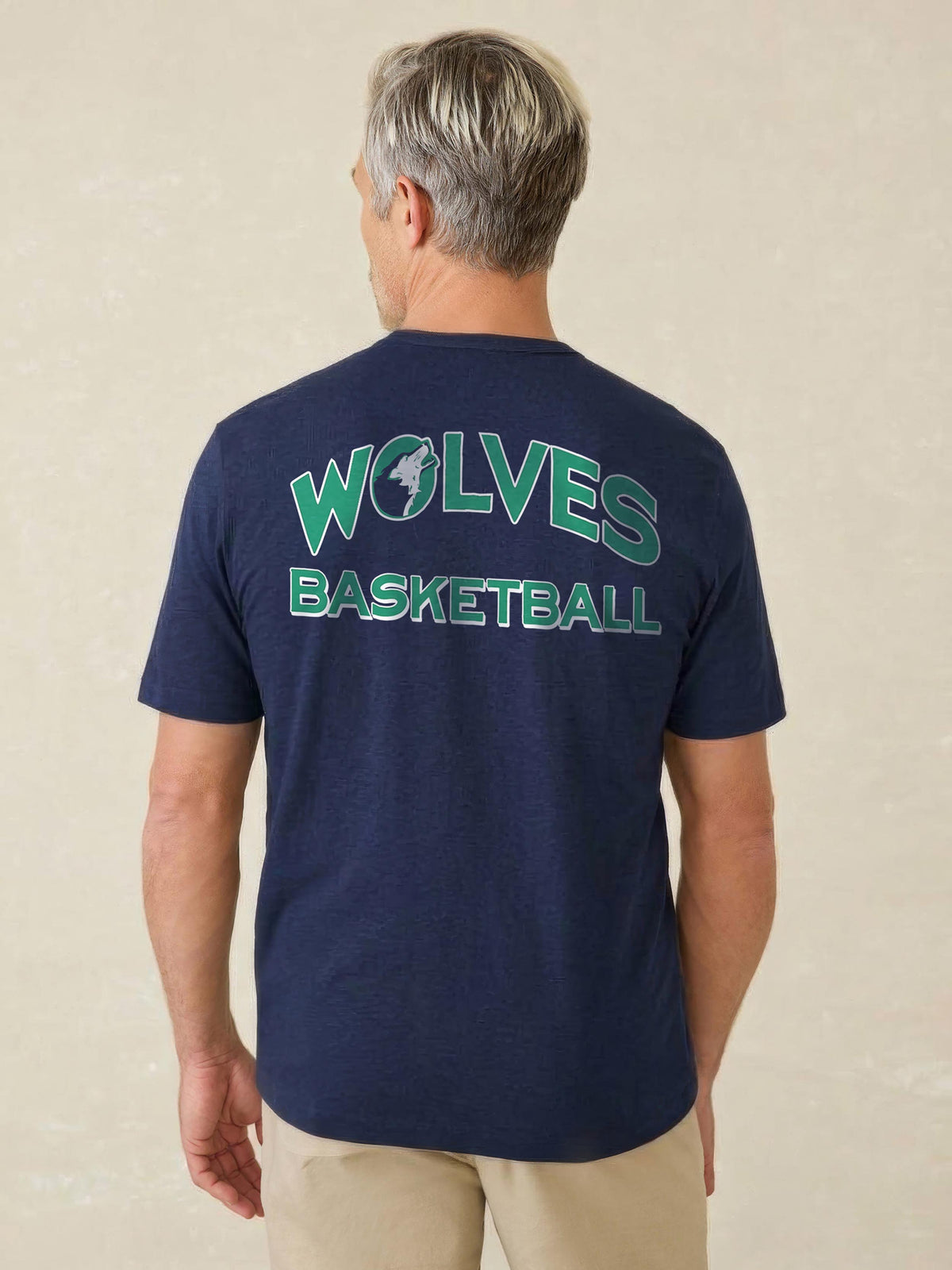 A man viewed from the back wearing a blue Minnesota Timberwolves tee , image 2 of 4