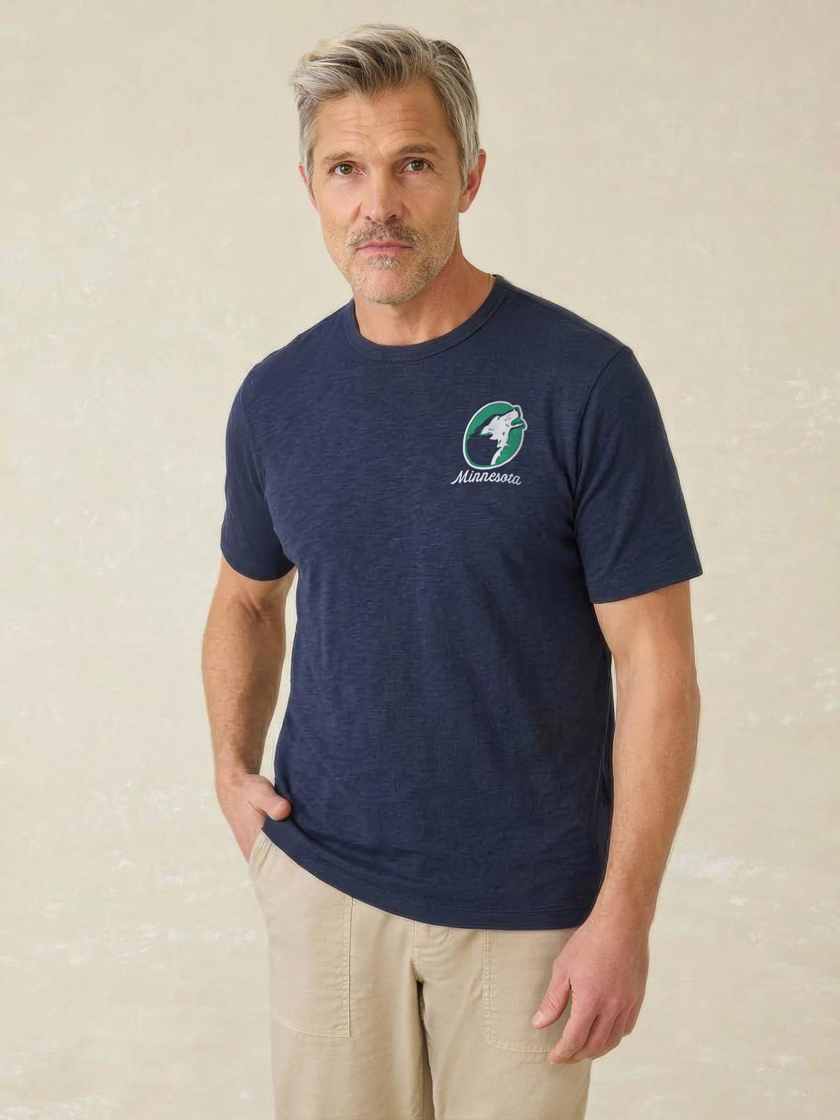 A man wearing a blue Minnesota Timberwolves tee , image 1 of 4
