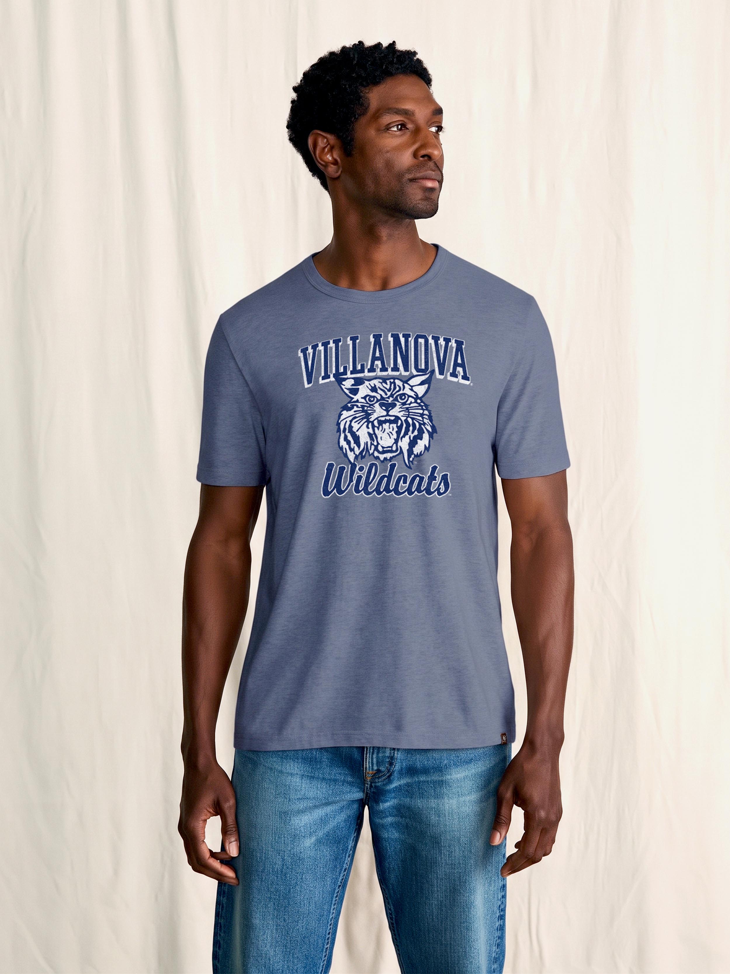 A man wearing a blue Villanova tee and blue jeans