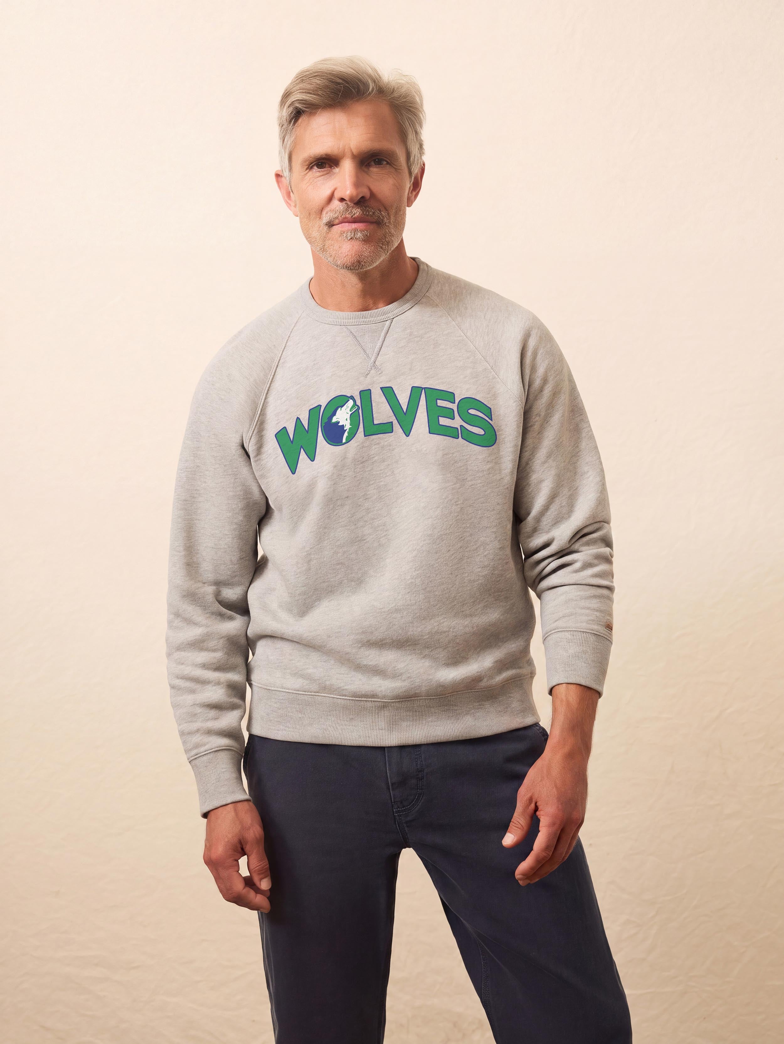 A man wearing a grey Minnesota Timberwolves crewneck