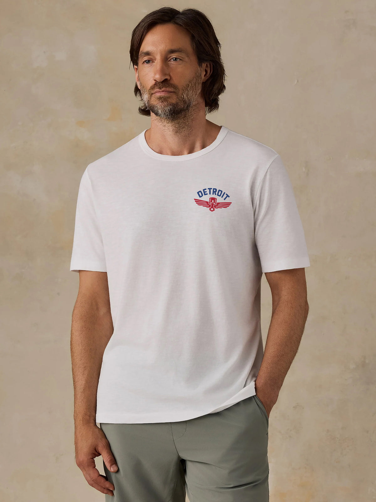 A man wearing a white Detroit Pistons tee, image 1 of 4