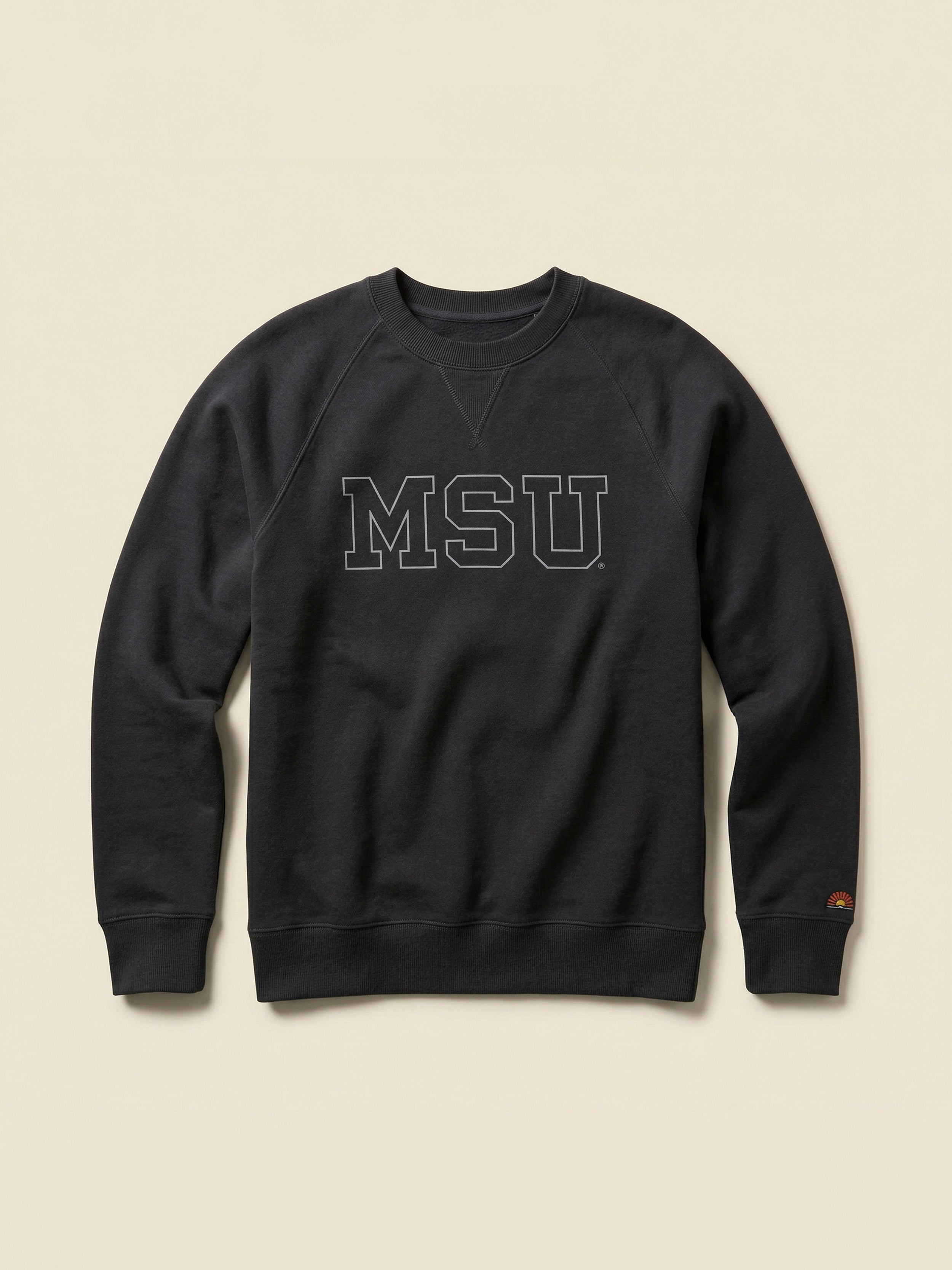 Black crewneck sweatshirt with Michigan State graphic on the center front against a beige background