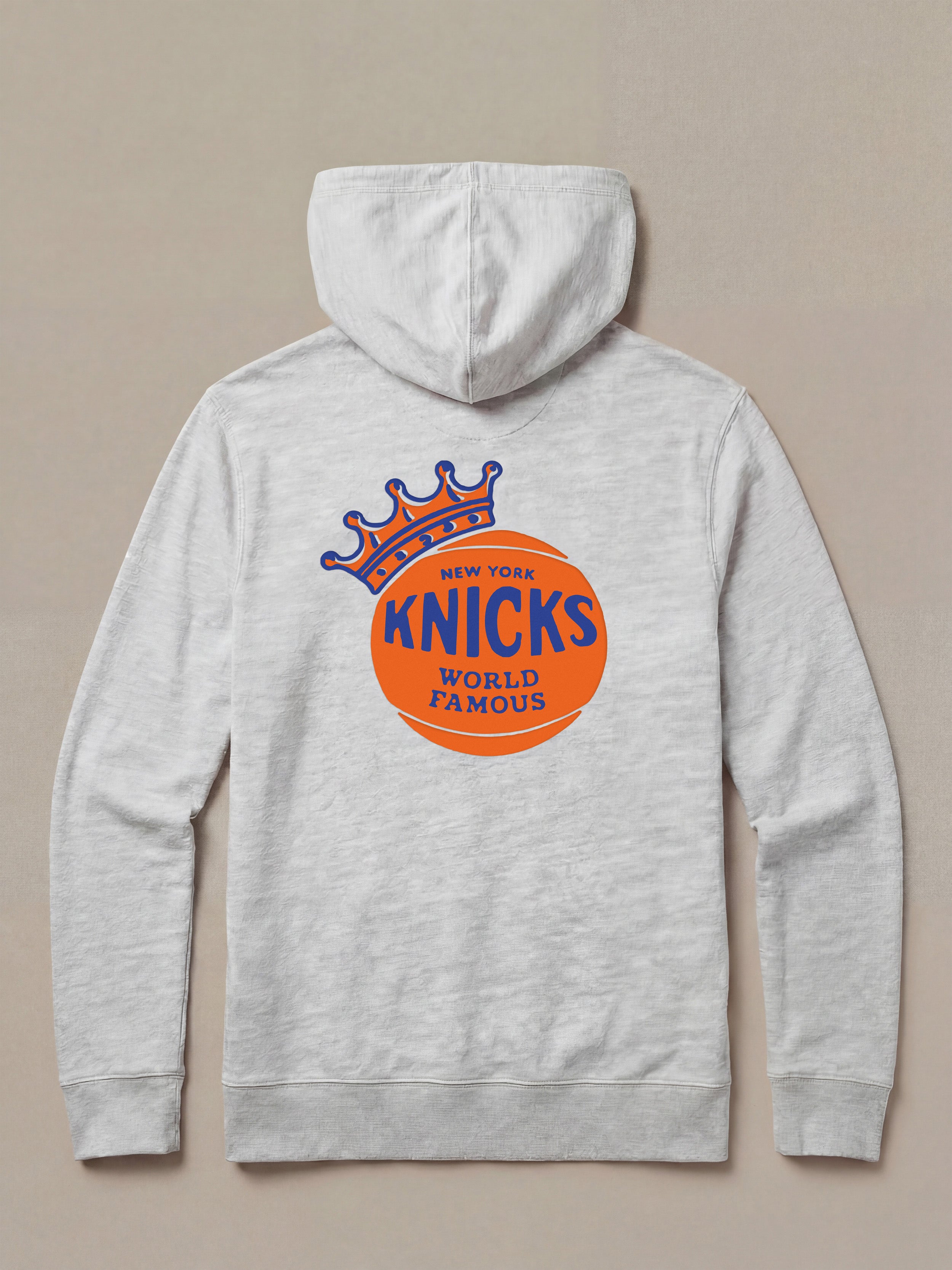 Gray hoodie with New York Knicks graphic logo on the back against a beige background