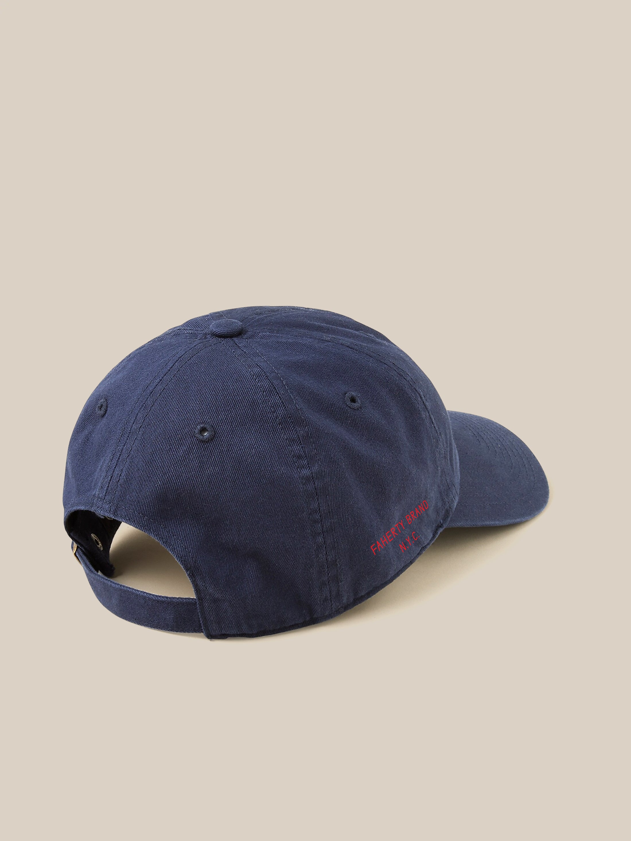 Navy blue baseball cap against a beige background