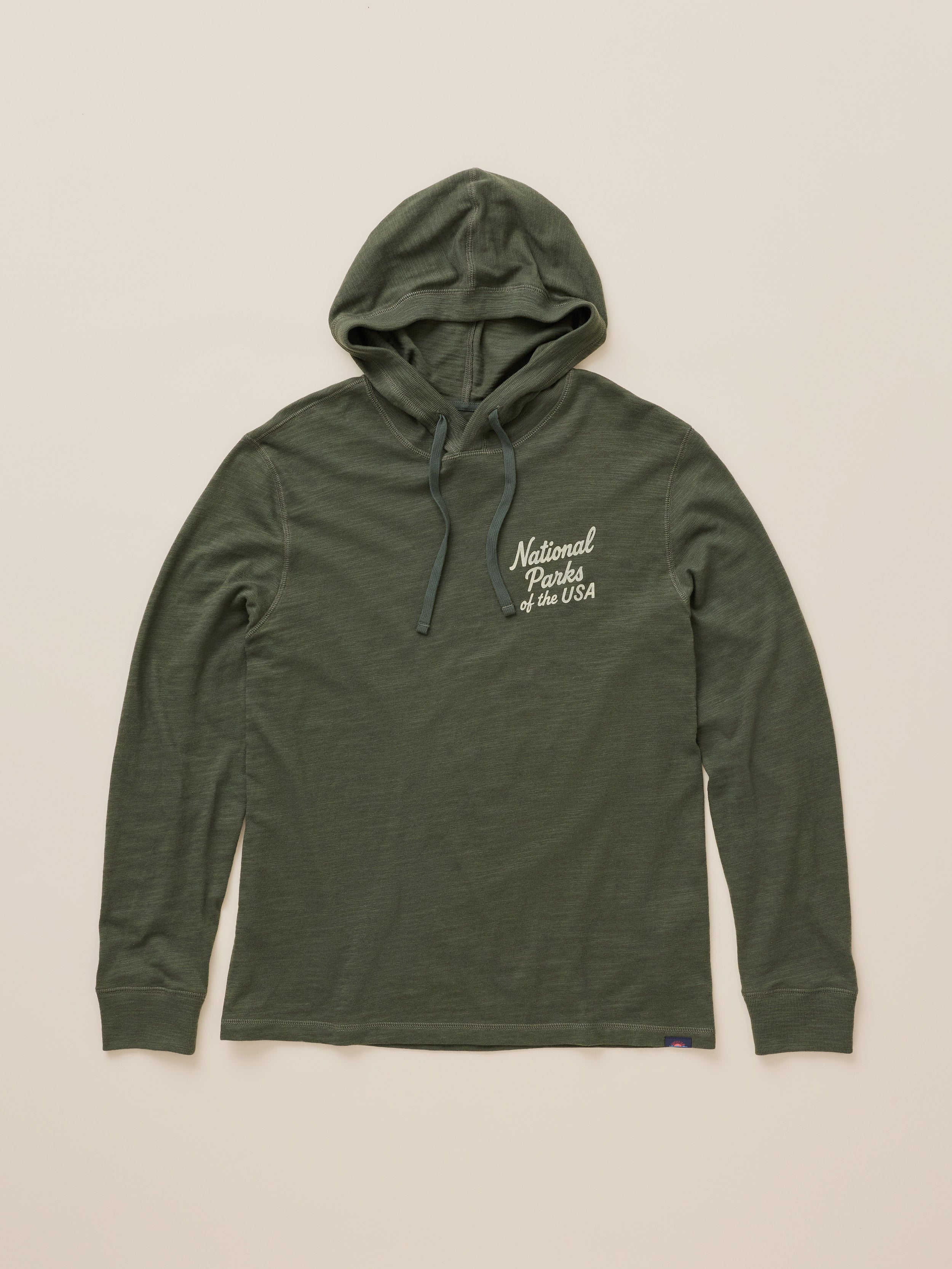 An olive green long-sleeve hooded sweatshirt with white embroidered text on the left chest reading 'Natural Parks of the USA', displayed flat against a light beige background.
