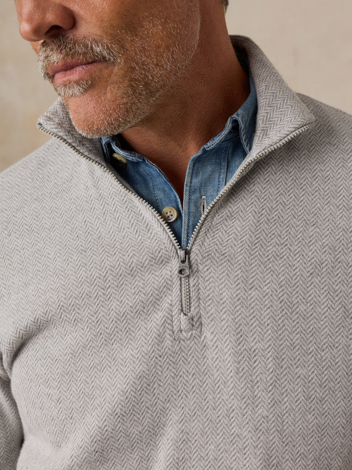 Close up of a man wearing a grey quarter zip, image 5 of 6