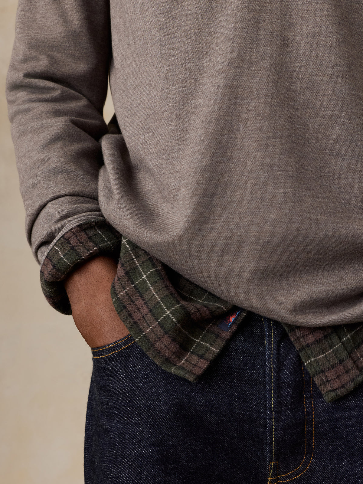 Close up of a man wearing a light brown quarter zip, image 3 of 5
