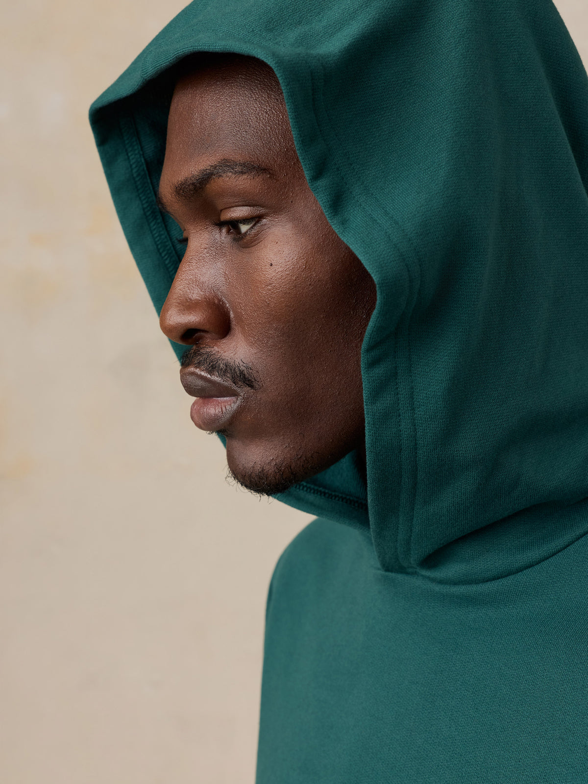 Close up of a man wearing a teal hoodie , image 6 of 6