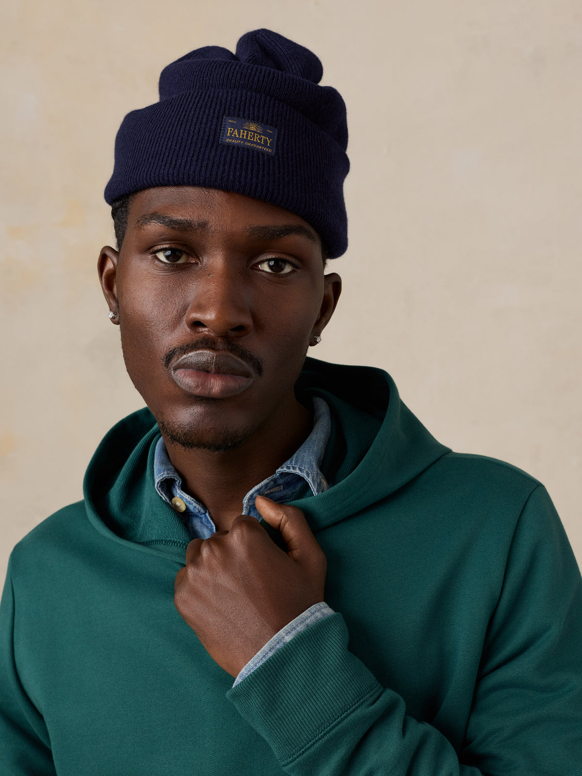 Close up of a man wearing a teal hoodie , image 5 of 6