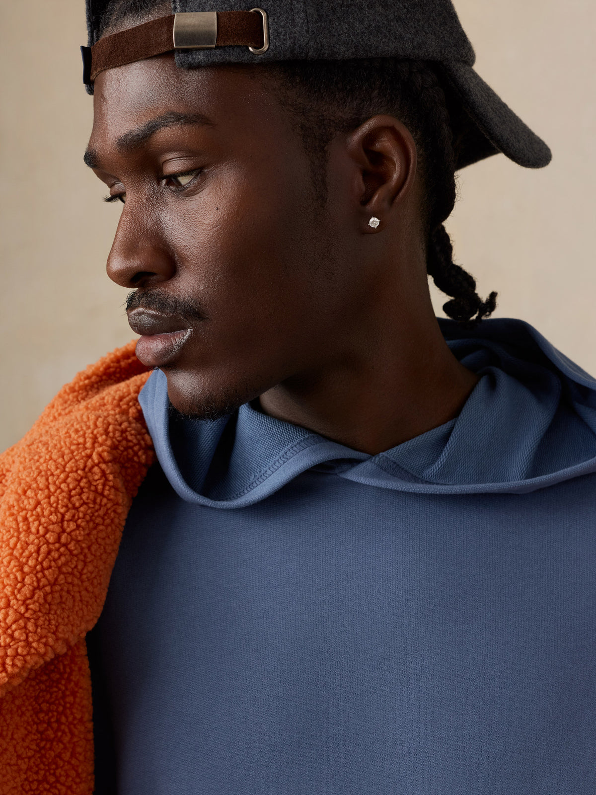 Close up of a man wearing a blue hoodie , image 4 of 5