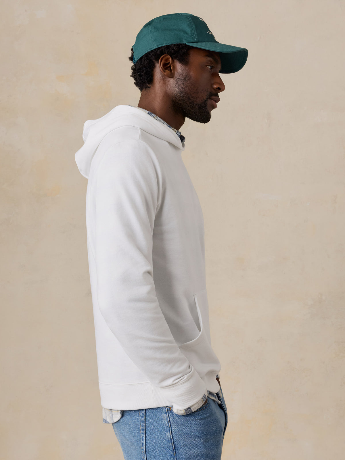 A man wearing a white hoodie , image 6 of 6