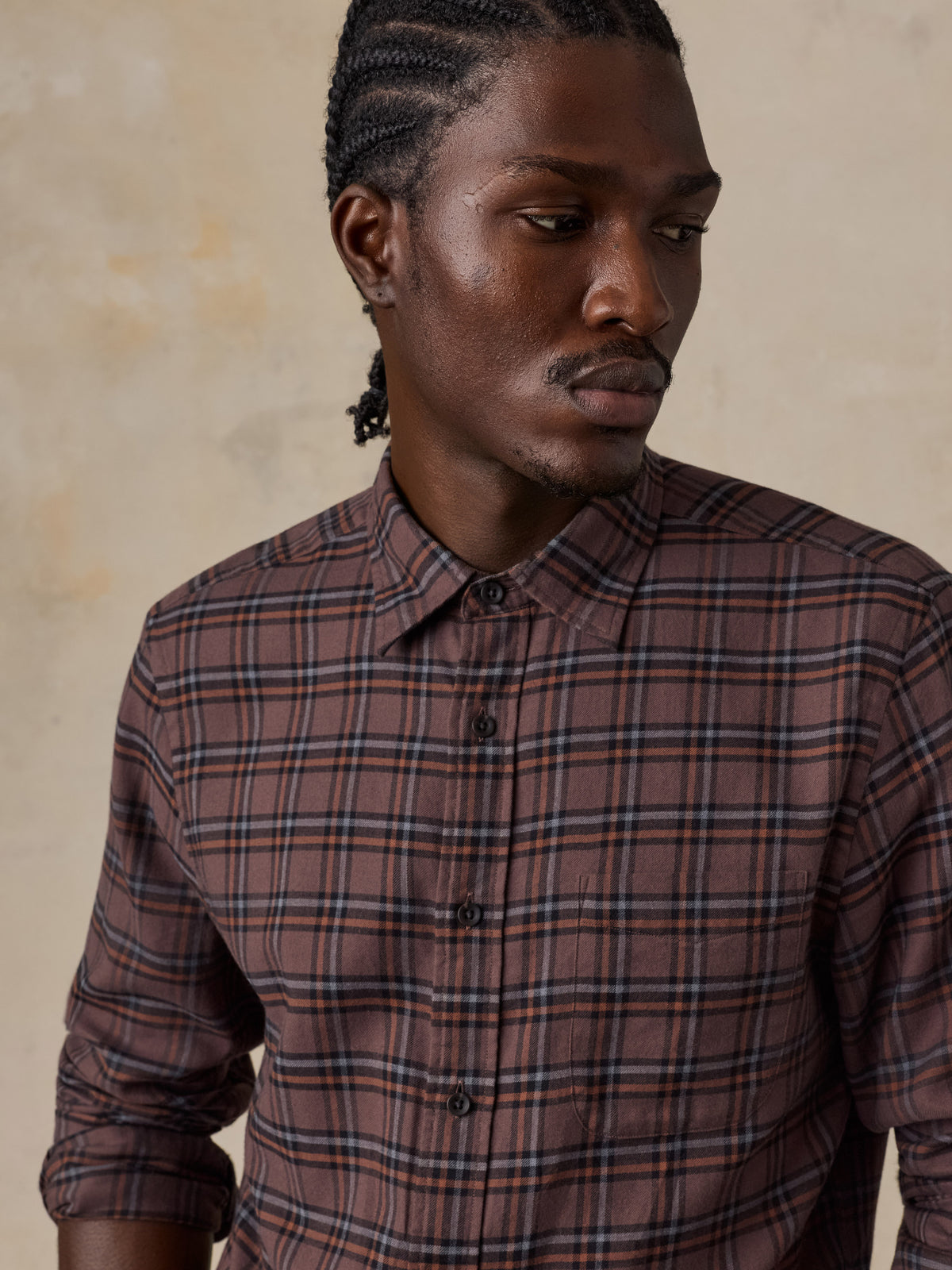 Close up of a man wearing a red plaid shirt, image 3 of 5