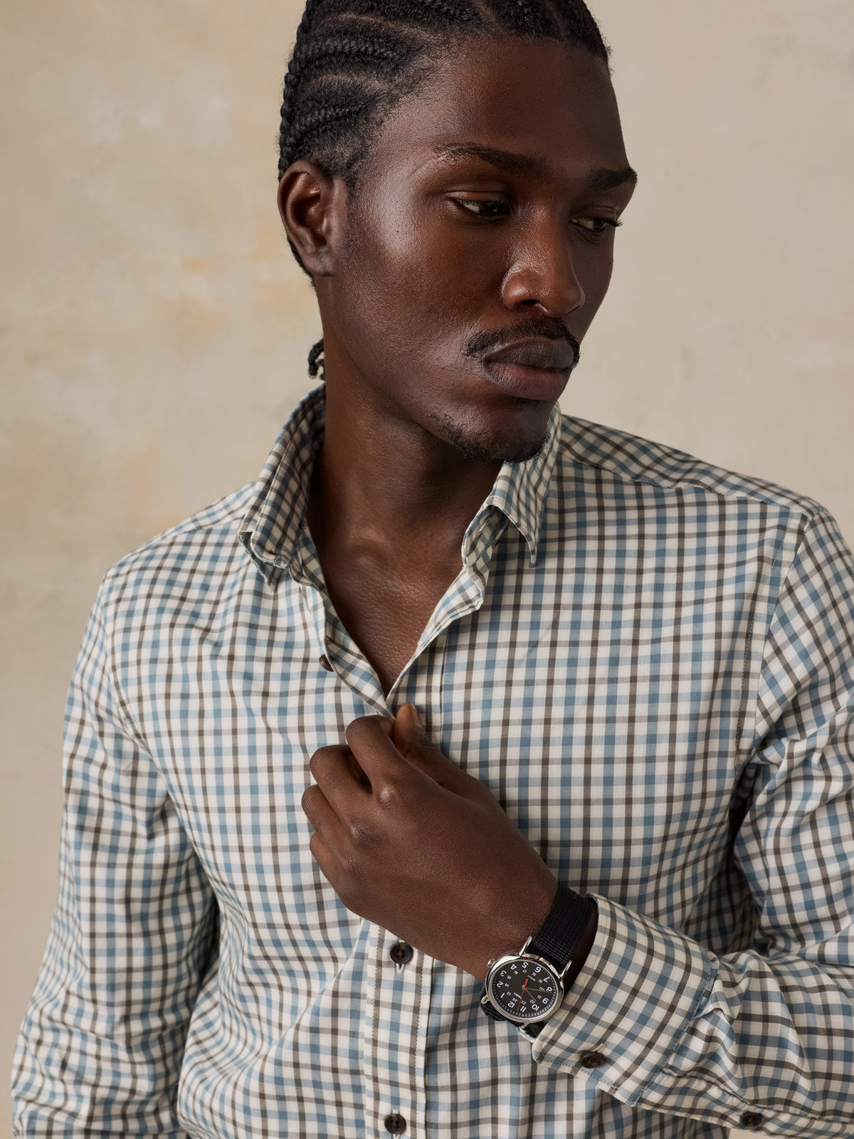 A man wearing a plaid shirt, image 3 of 5