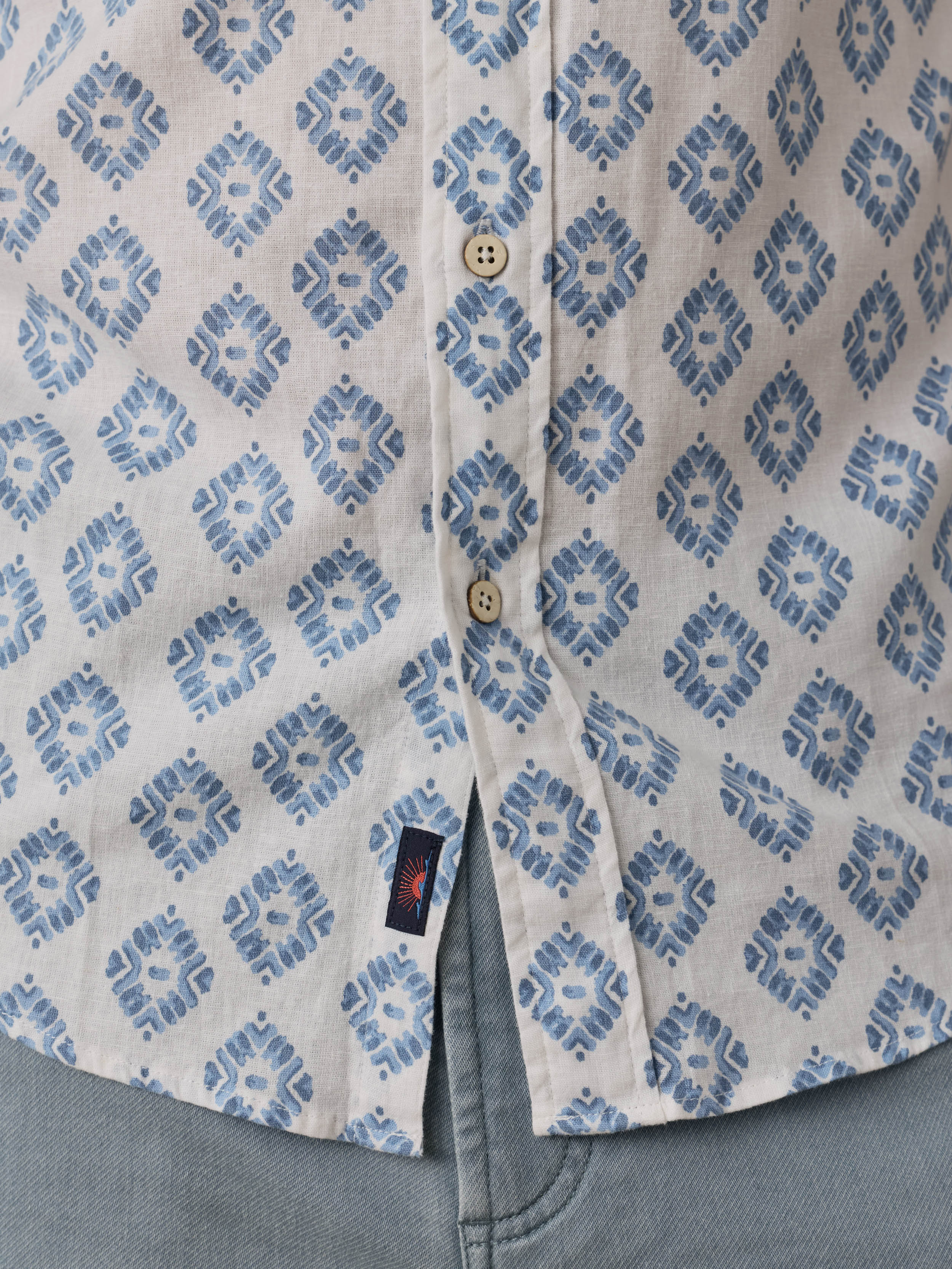 Close-up of a shirt with blue geometric pattern and visible Faherty brand tag.