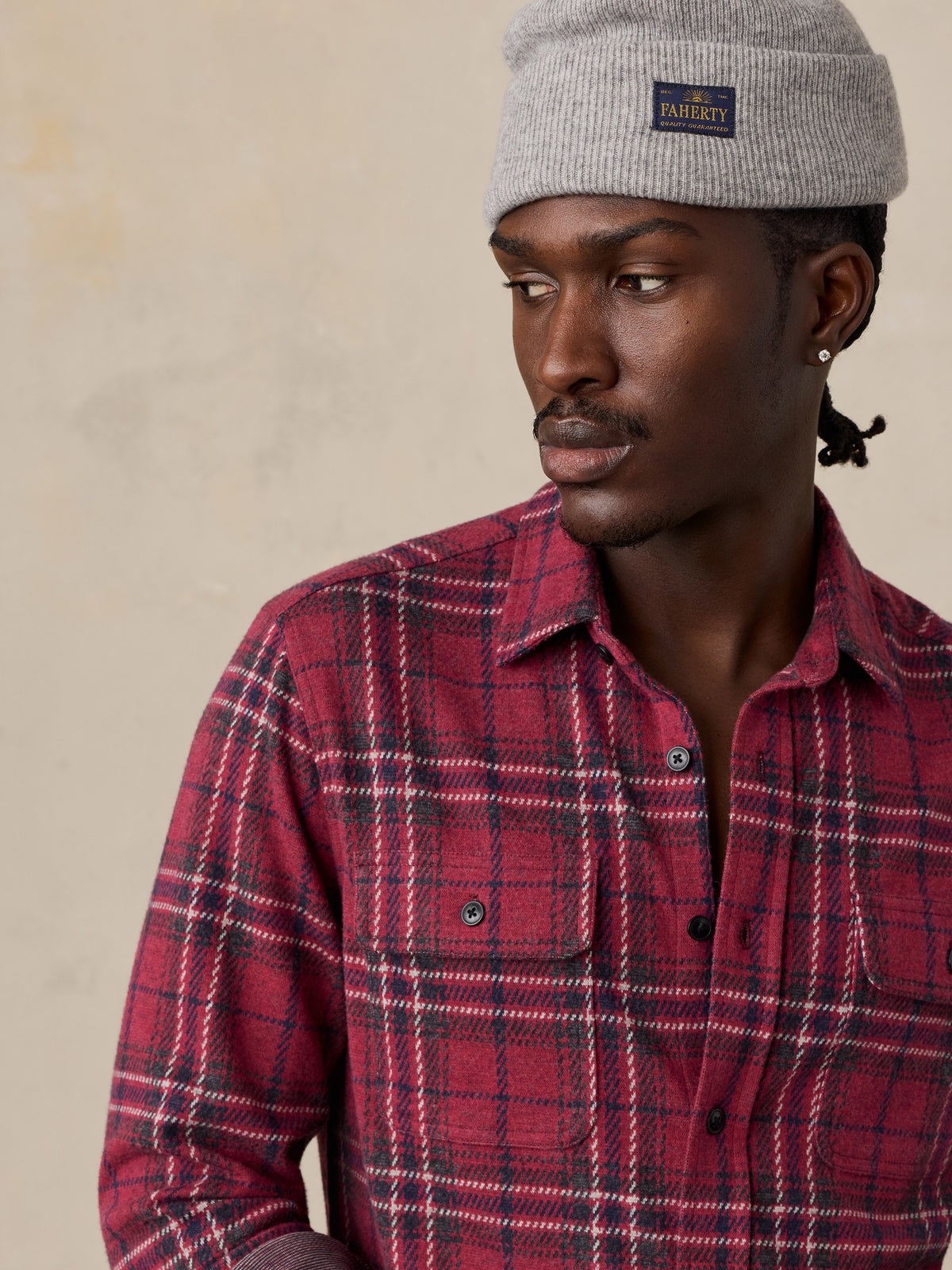 Close up of a man wearing a red button up shirt, image 3 of 6
