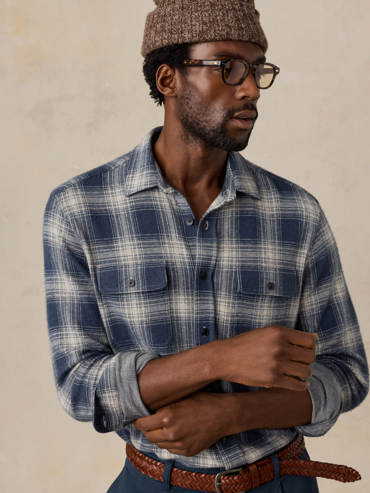Close up of a man wearing a blue button up shirt and a brown beanie, image 3 of 5