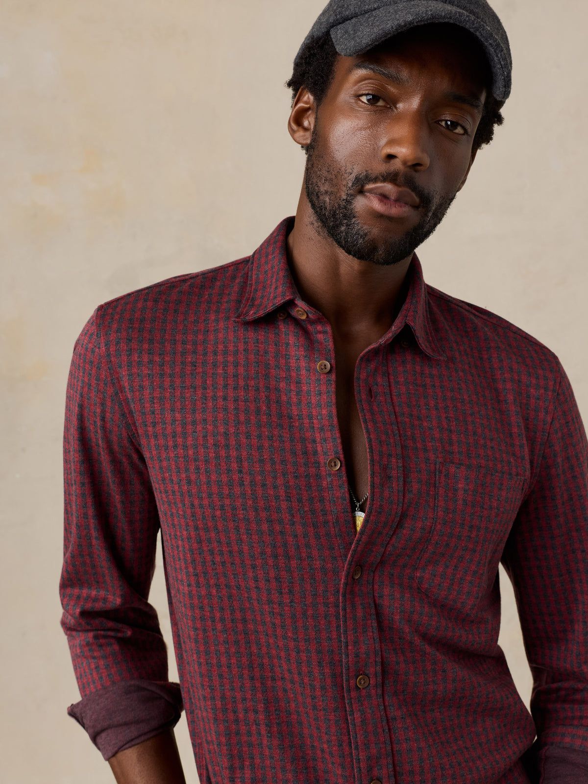Close up of a man wearing a red gingham shirt, image 5 of 5