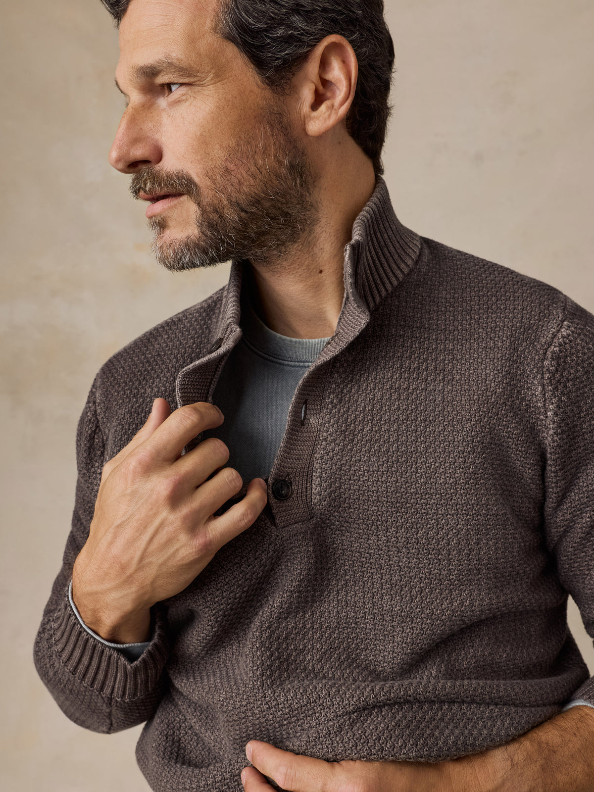 Close up of a man wearing a brown sweater, image 2 of 5