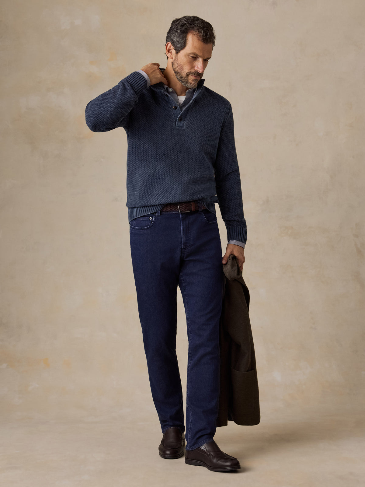 Man wearing a blue button up sweater and navy pants, image 5 of 5