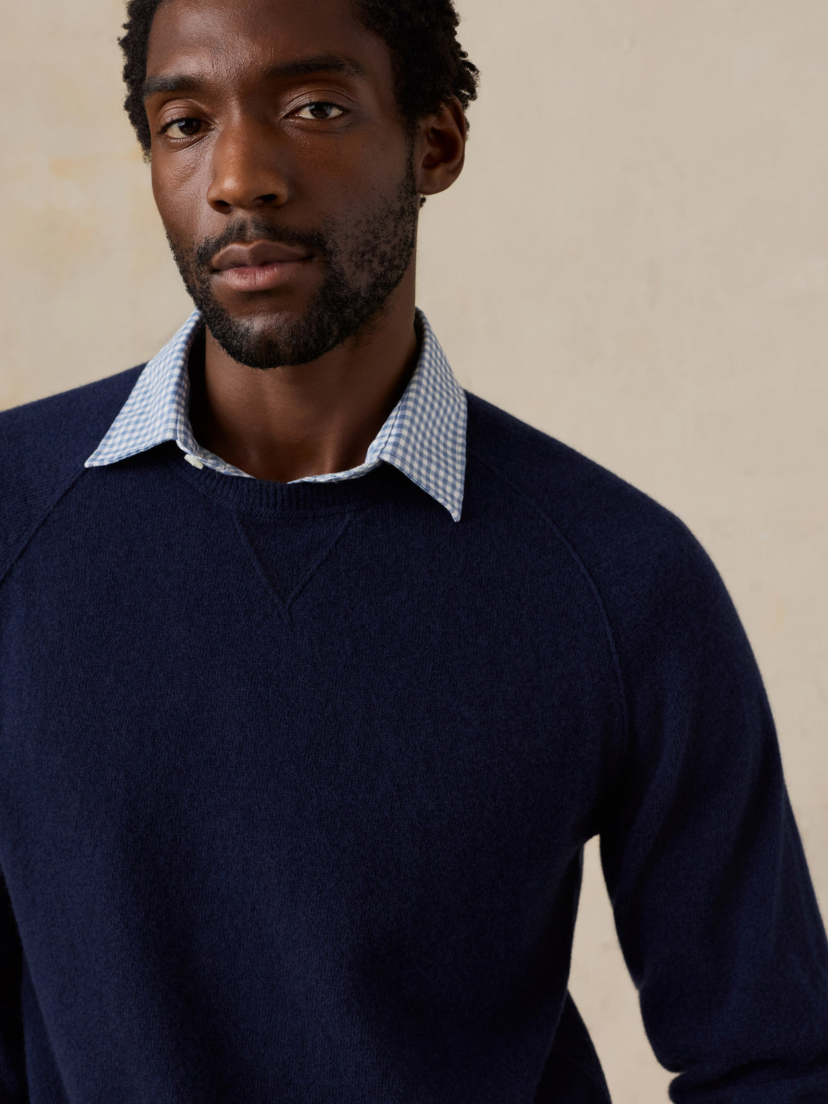 Close up of a man wearing a blue crewneck , image 5 of 7