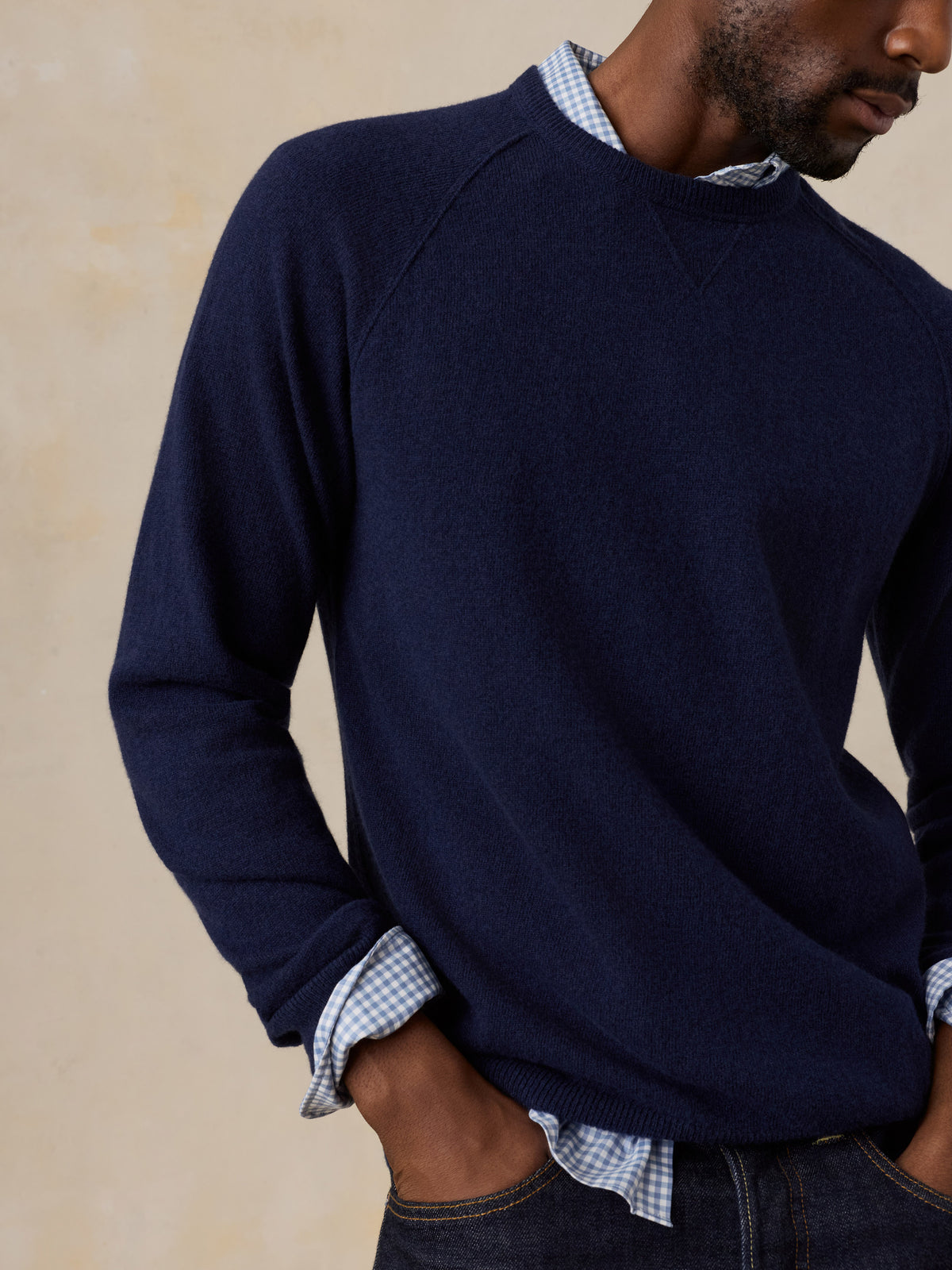 Close up of a man wearing a blue crewneck , image 3 of 7