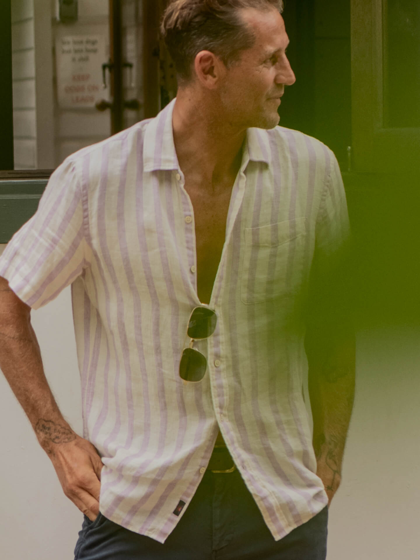 a man wearing a pink striped palma linen short sleeve tee shirt