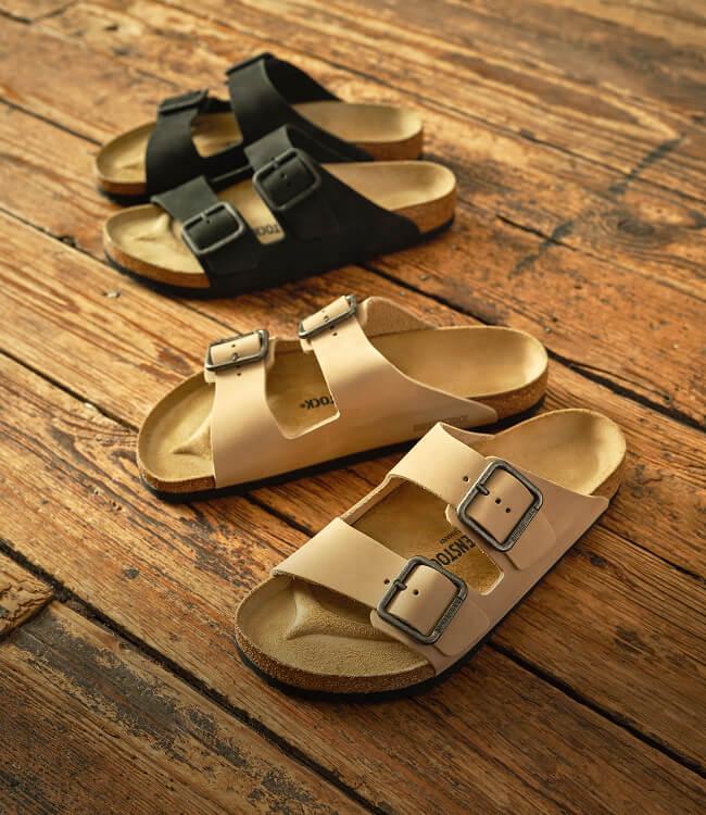 Birkenstock + Faherty Arizona sandals on a wooden floor