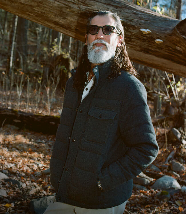 Male model in the winter forest wearing an insulated deck jacket