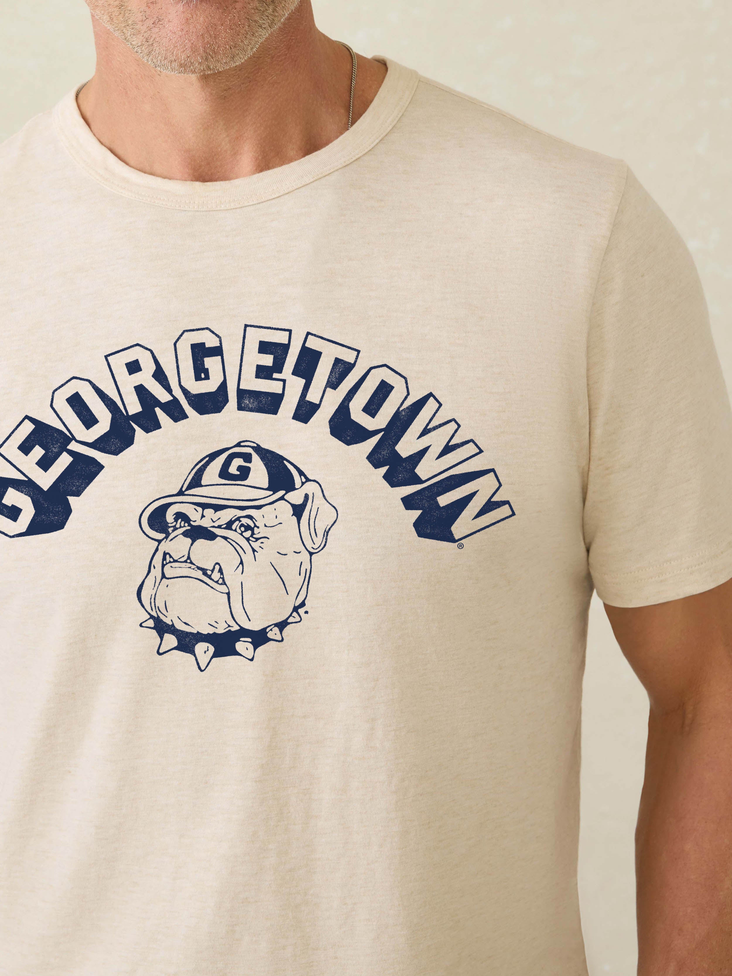 Heather grey short sleeve t-shirt with Georgetown graphic at the front against a beige background