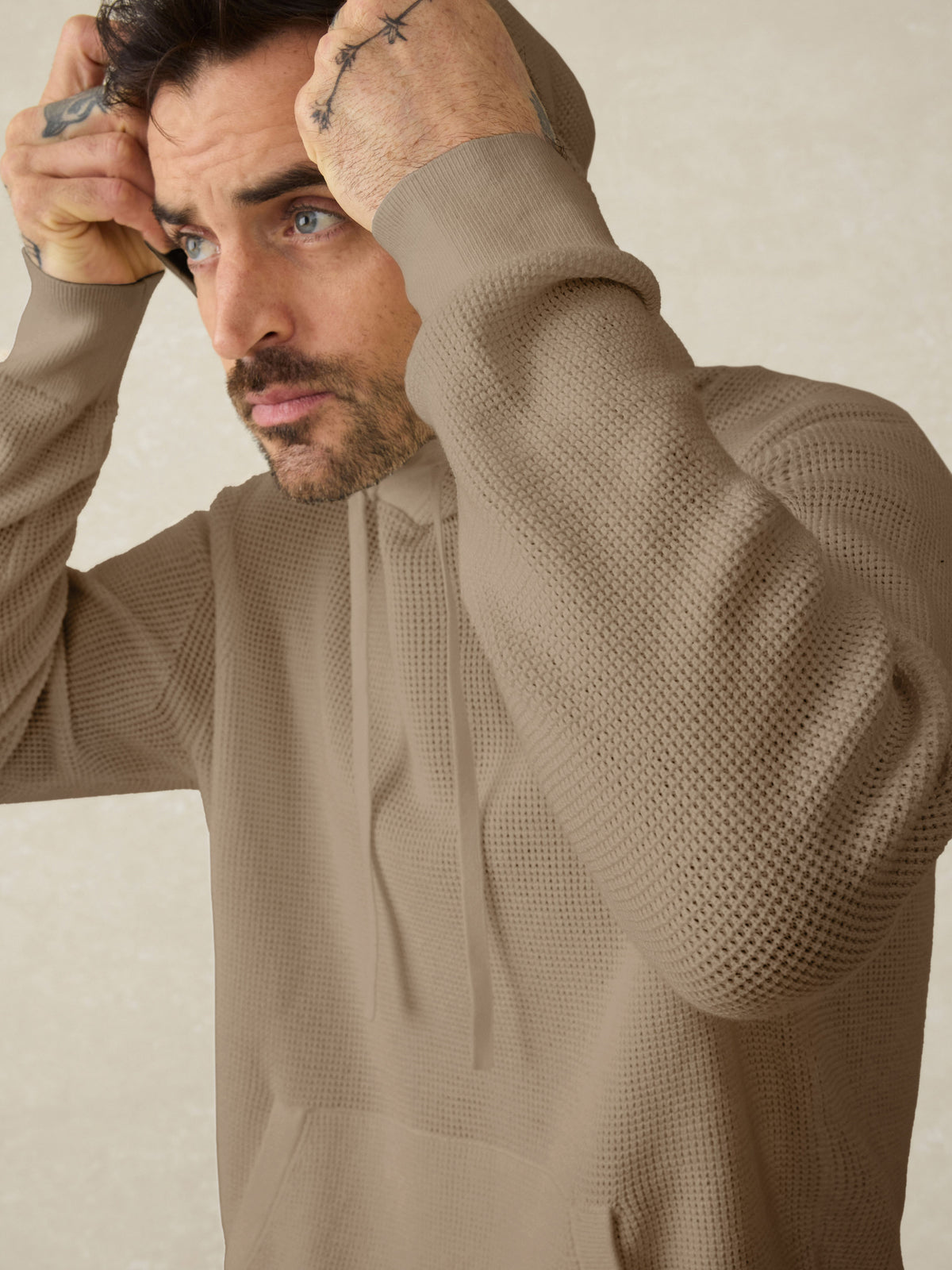 Close up of a man wearing a tan hoodie , image 3 of 5