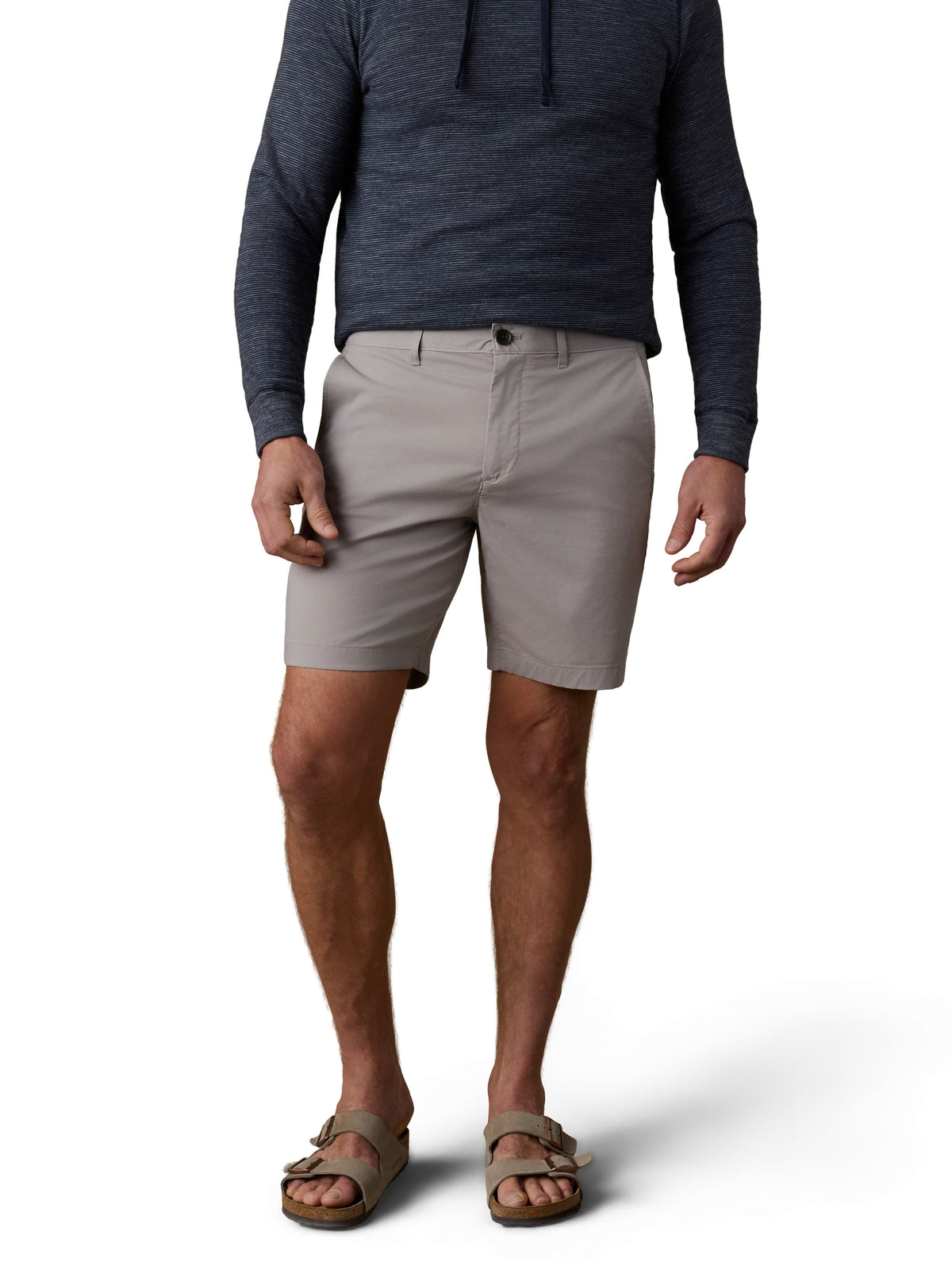 A man wearing a blue hoodie, grey shorts, and birkenstocks, image 2 of 3