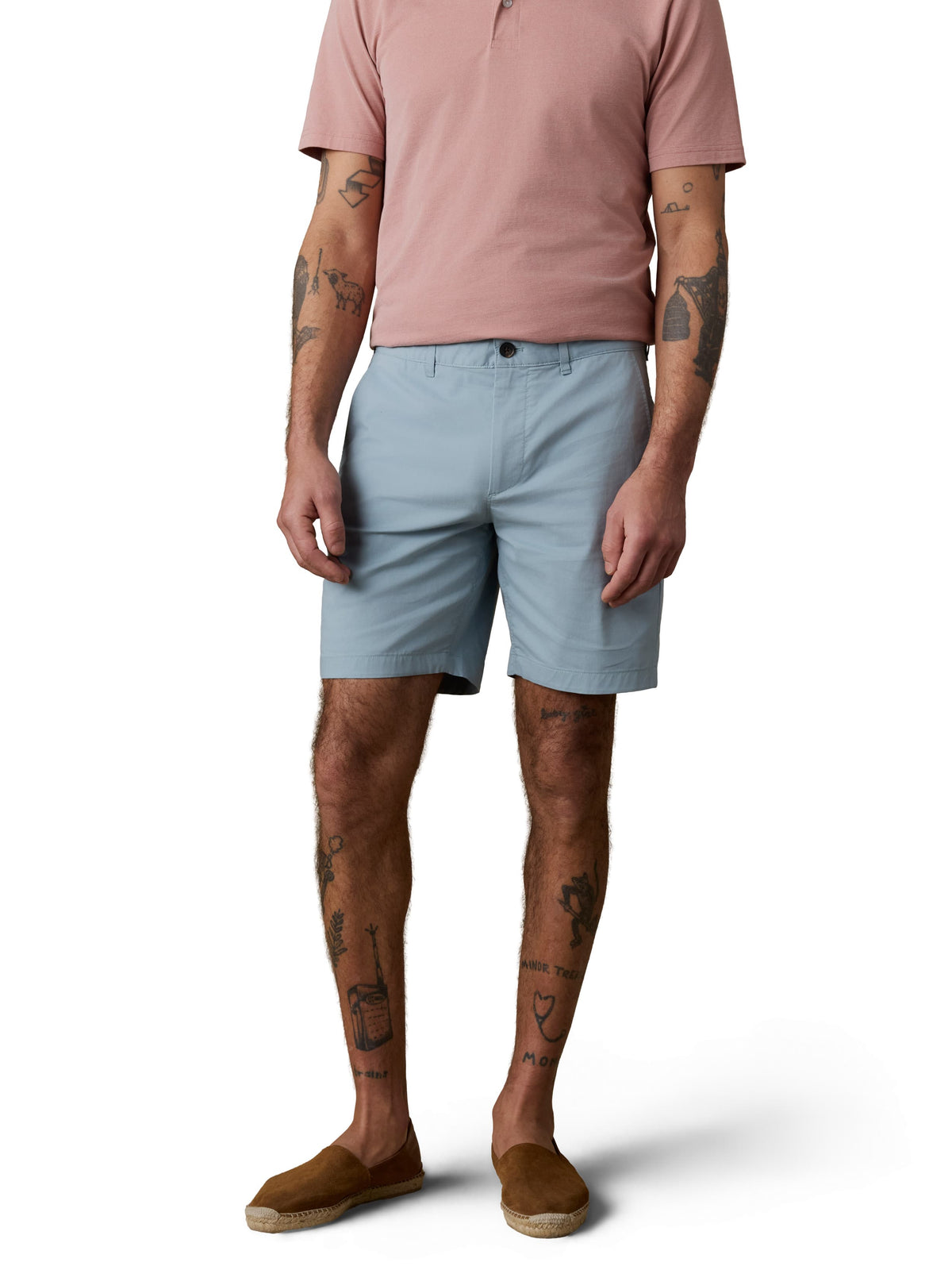 A man wearing a pink polo and light blue shorts, image 2 of 3