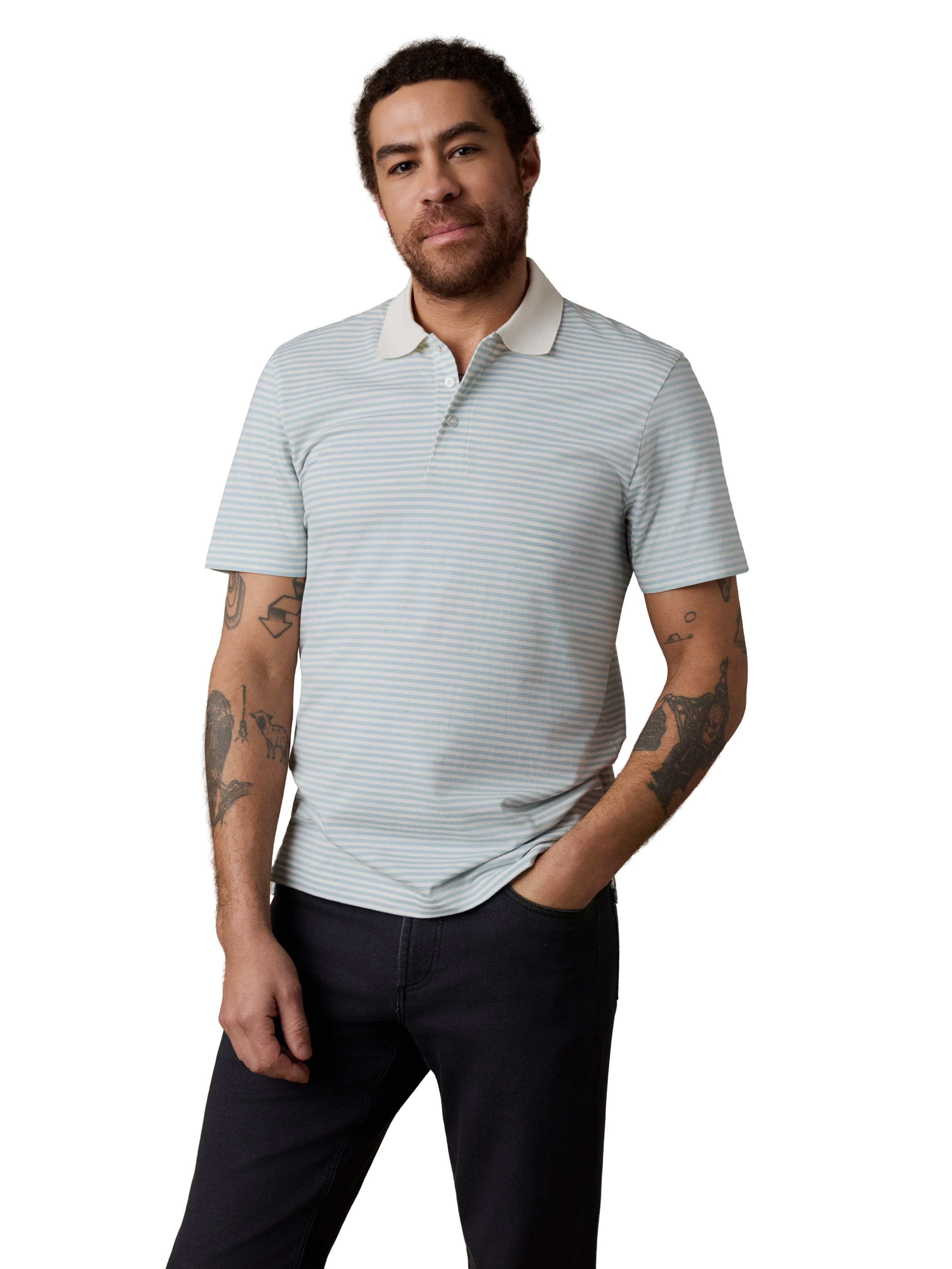 Man wearing a light blue striped polo shirt and dark jeans