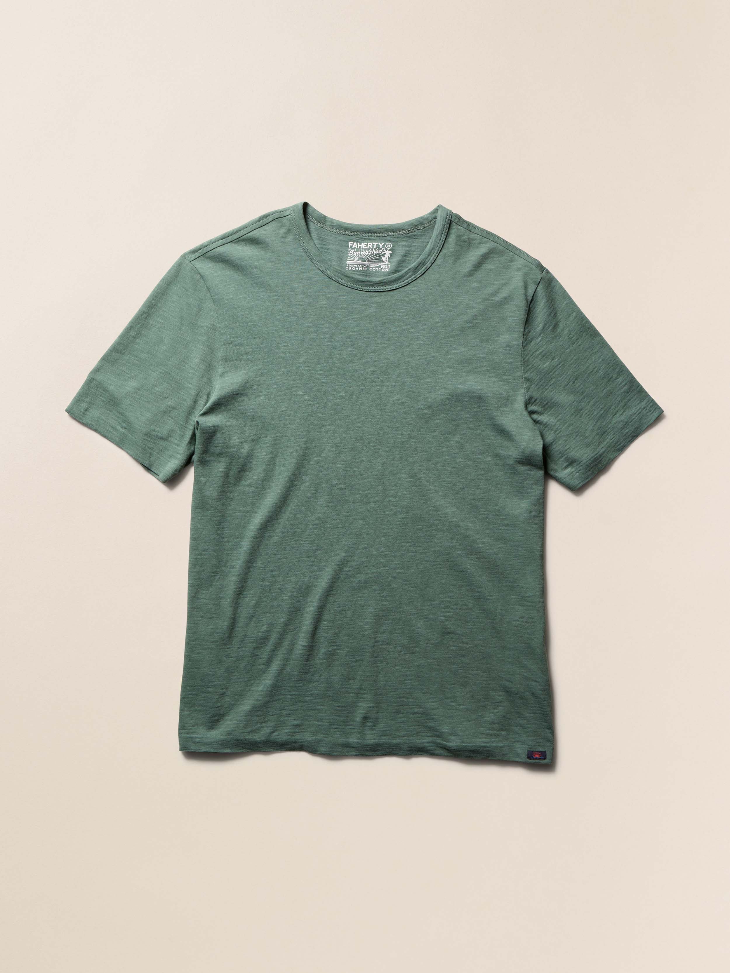 Green t-shirt on a beige background