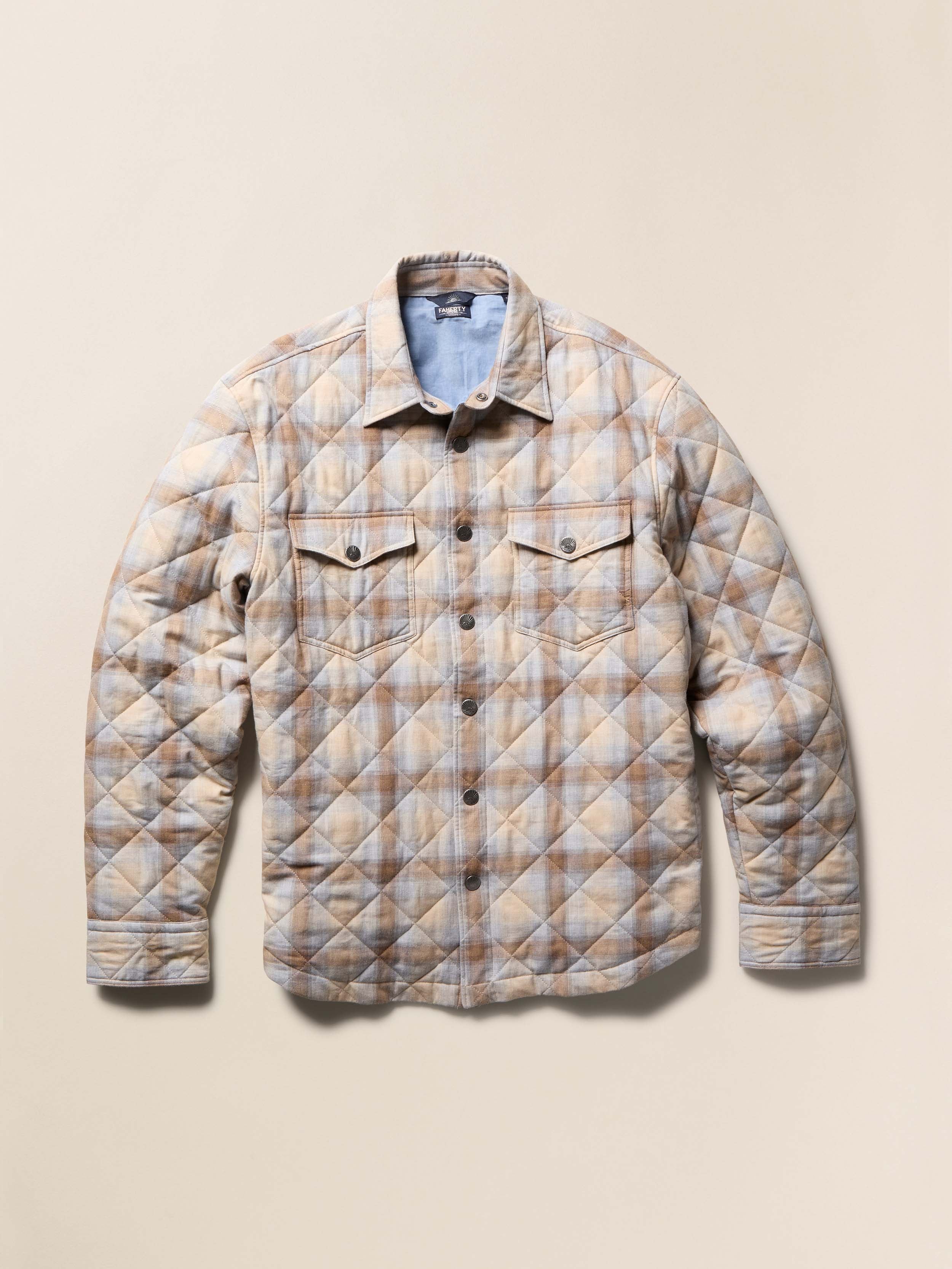 Beige quilted plaid jacket on a beige background