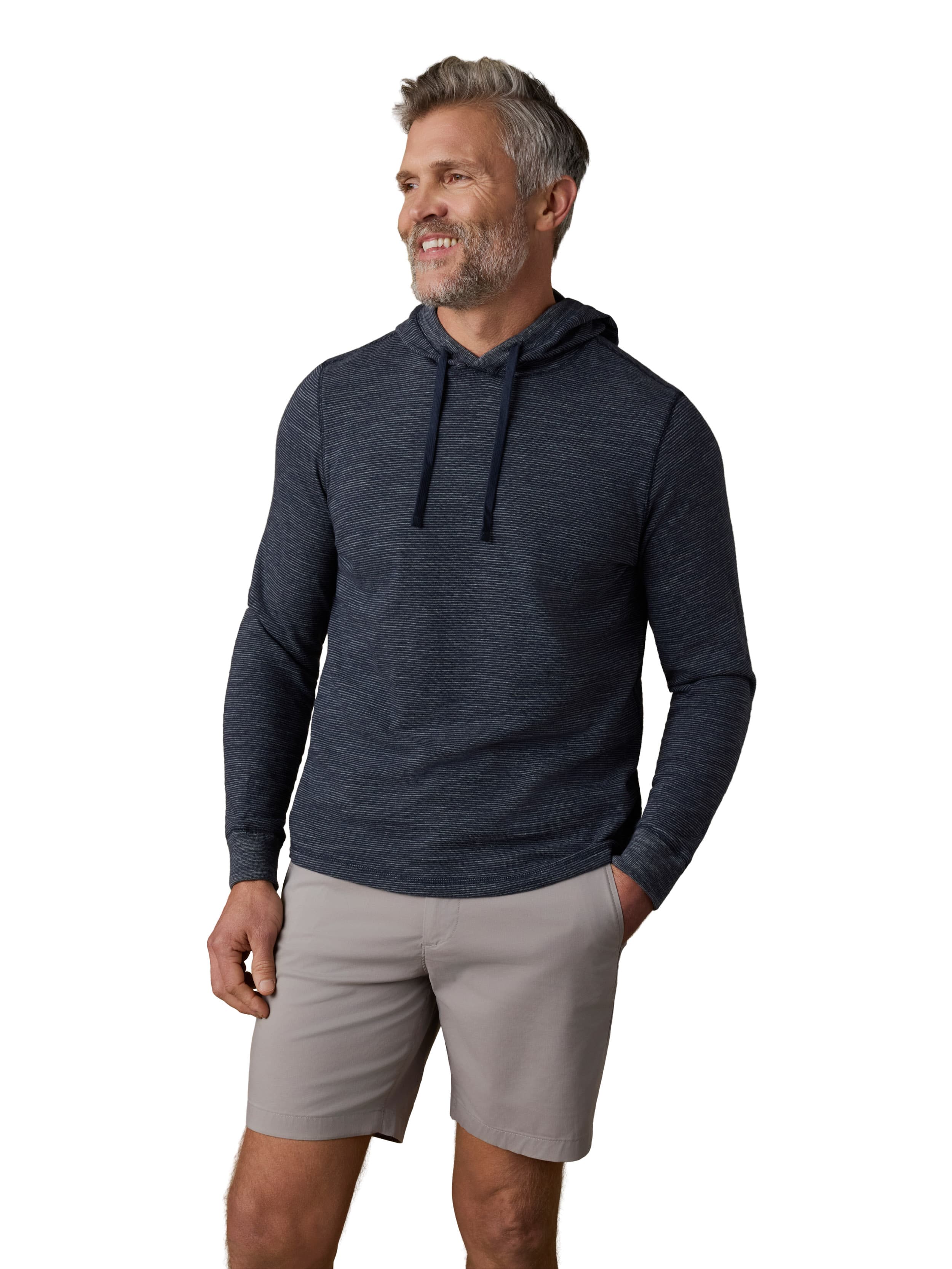A man wearing a navy hoodie and grey shorts
