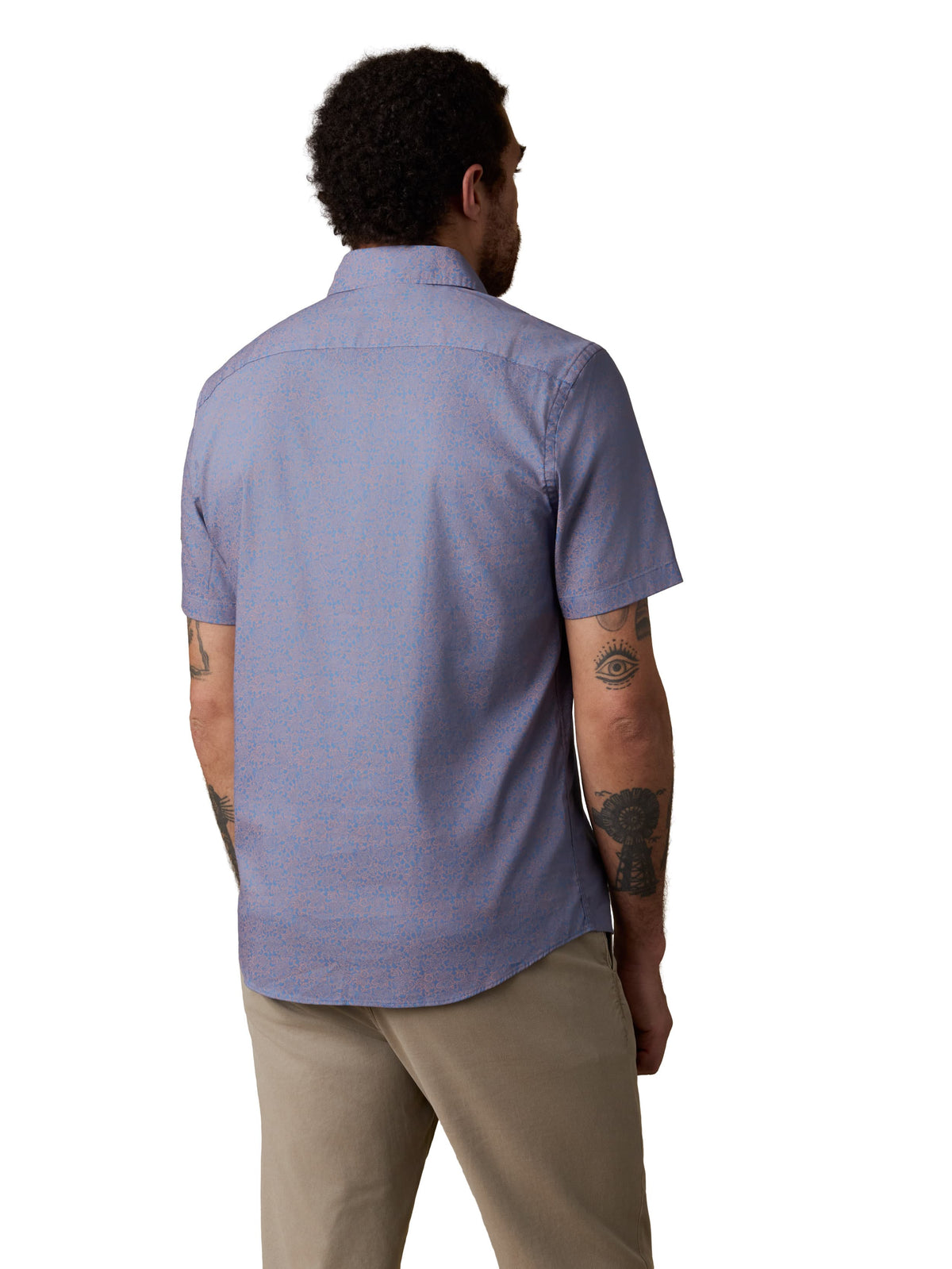 A man viewed from behind wearing a blue button up shirt and beige pants, image 3 of 3
