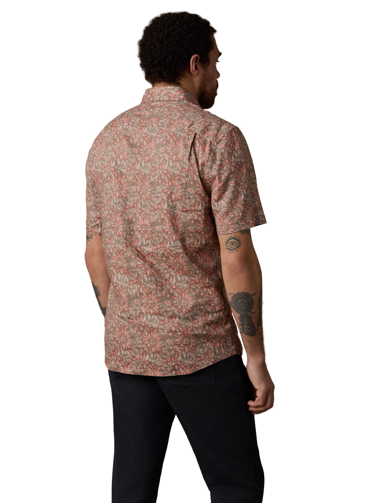 A viewed from behind man wearing a red printed top and black pants, image 3 of 3