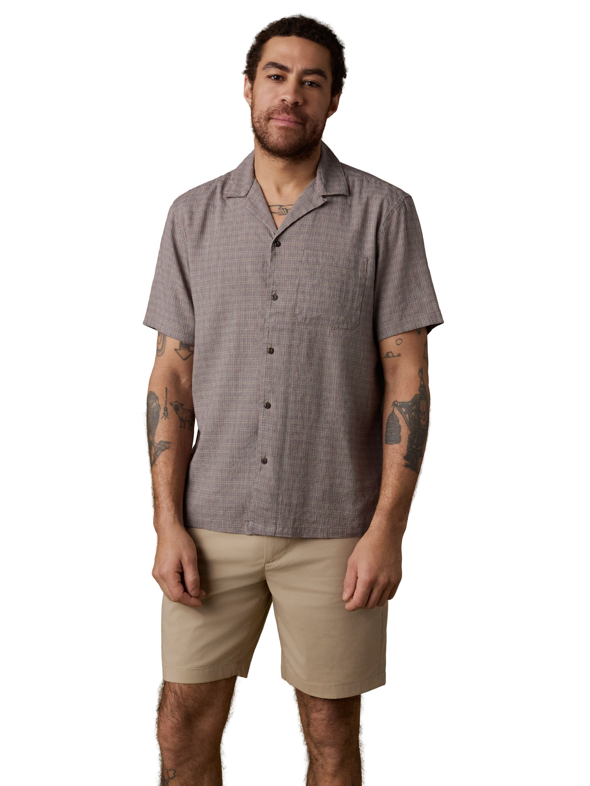 A man wearing a grey shirt and beige shorts, image 1 of 2