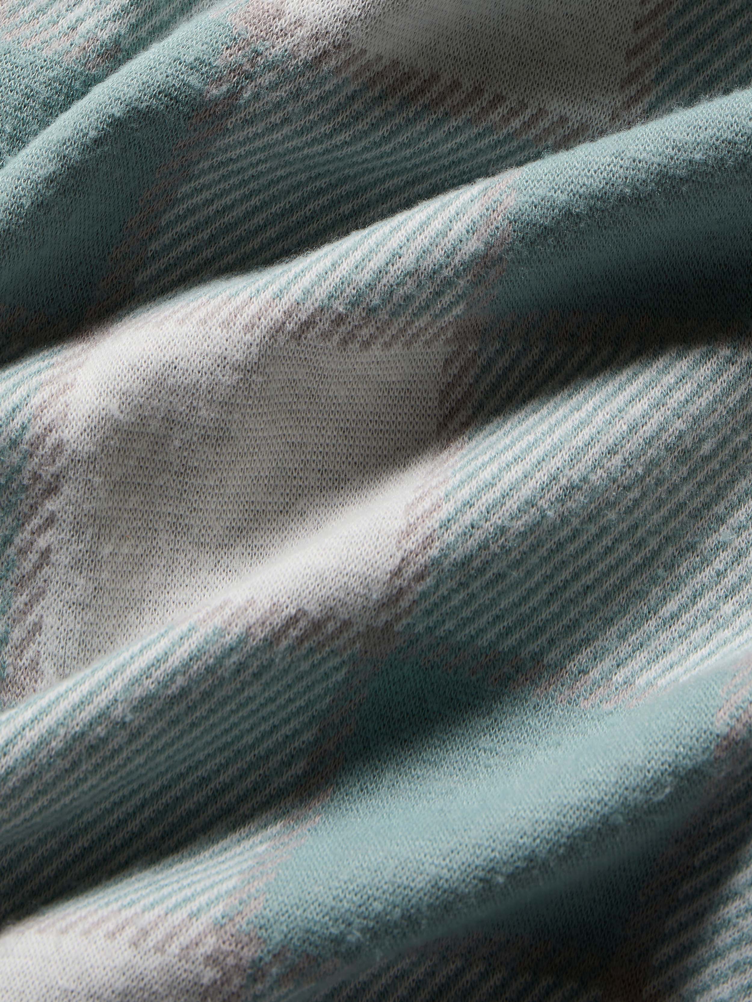 Close-up of textured fabric with a plaid pattern in shades of blue and gray.